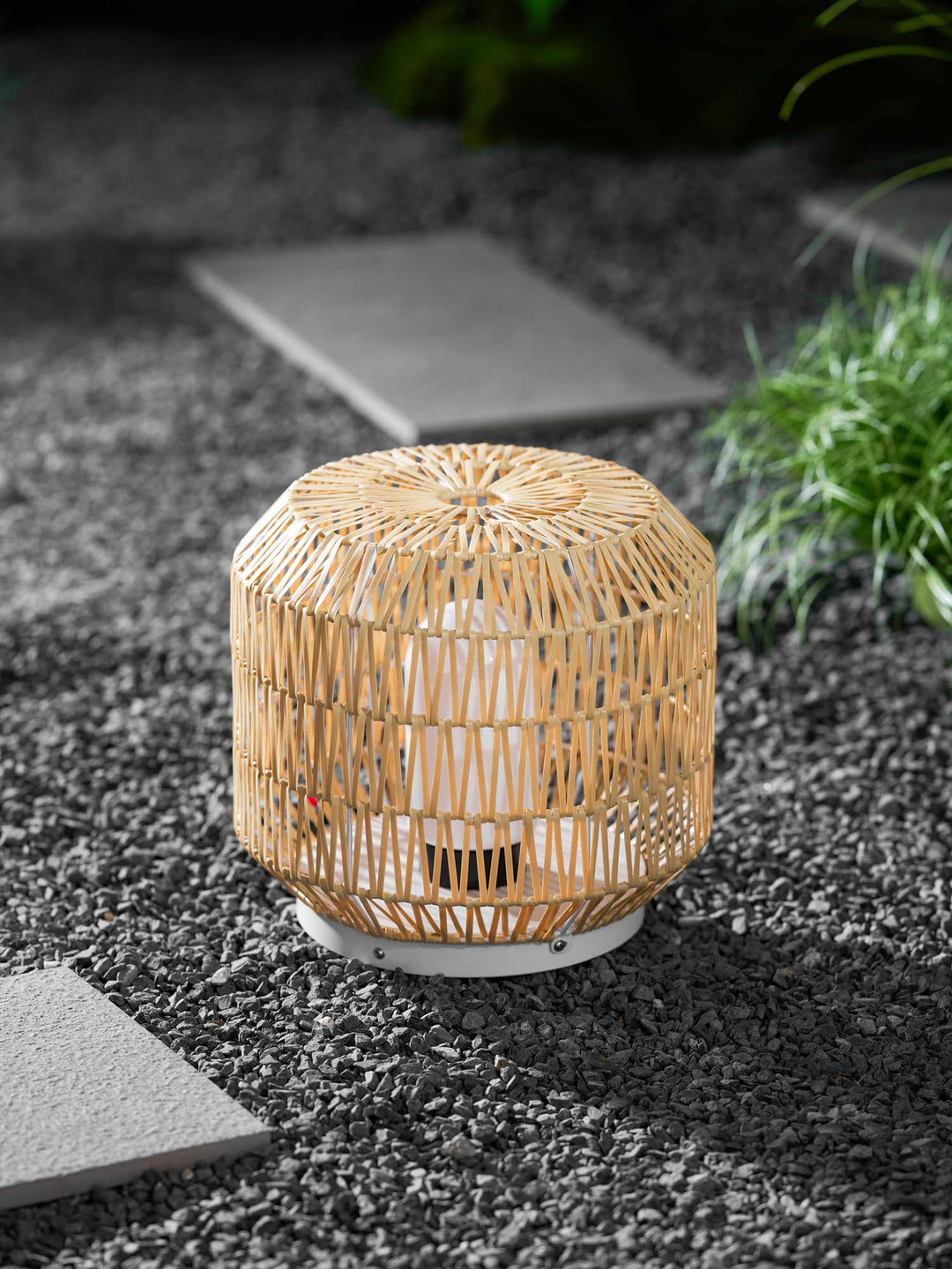 Woven rattan lamp styled on a modern outdoor deck.