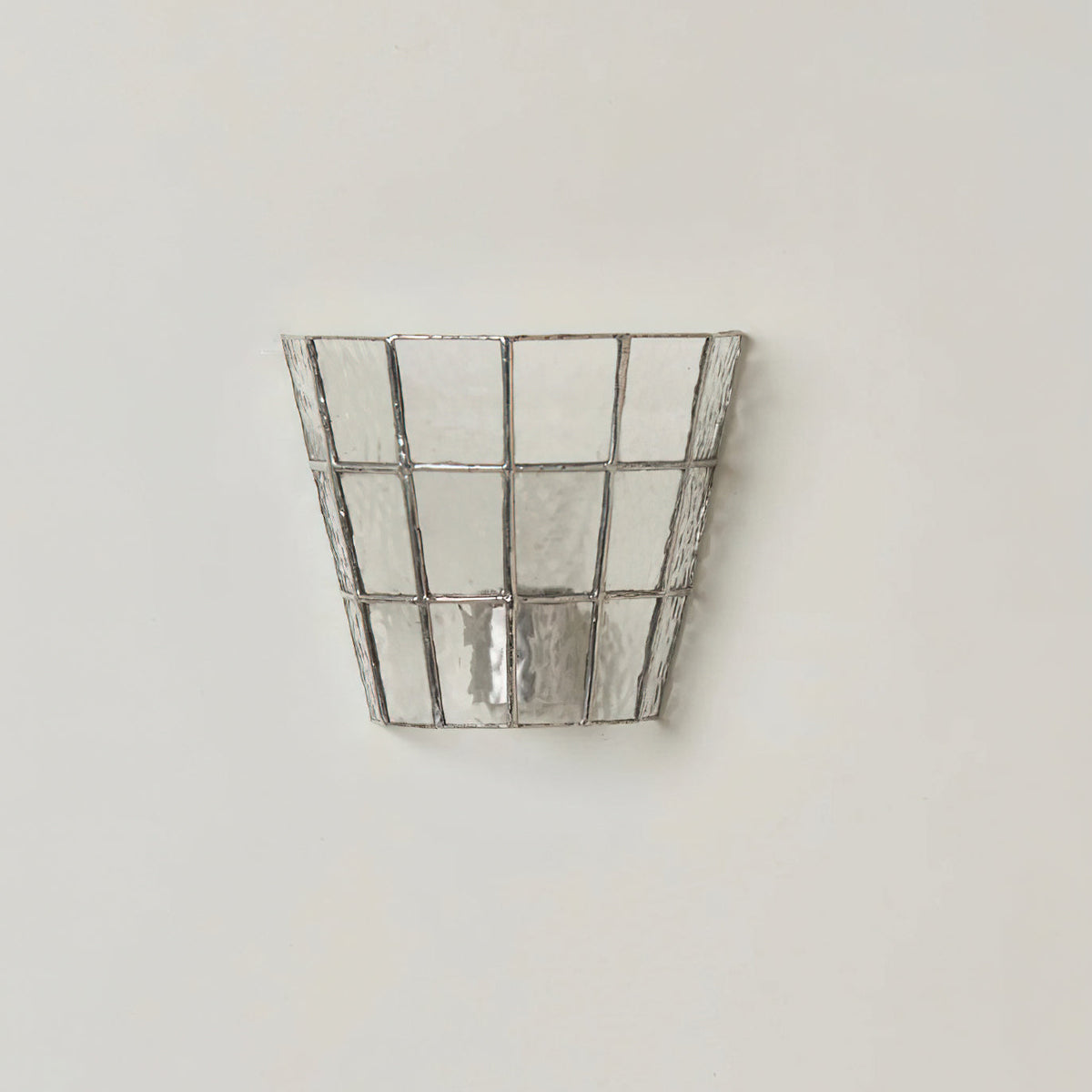 Zola Glass Sconce providing accent lighting in a stylish interior.