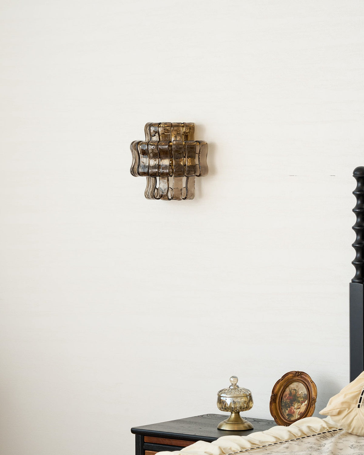 Albano Wall Lamp in clear glass next to a vanity.