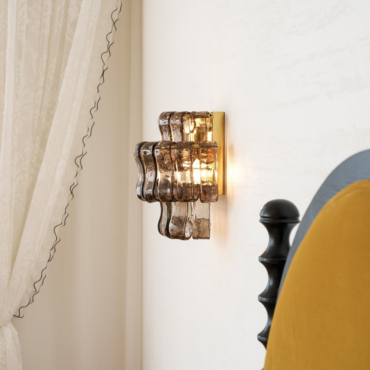 Albano Wall Lamp in green glass in an eclectic living space.