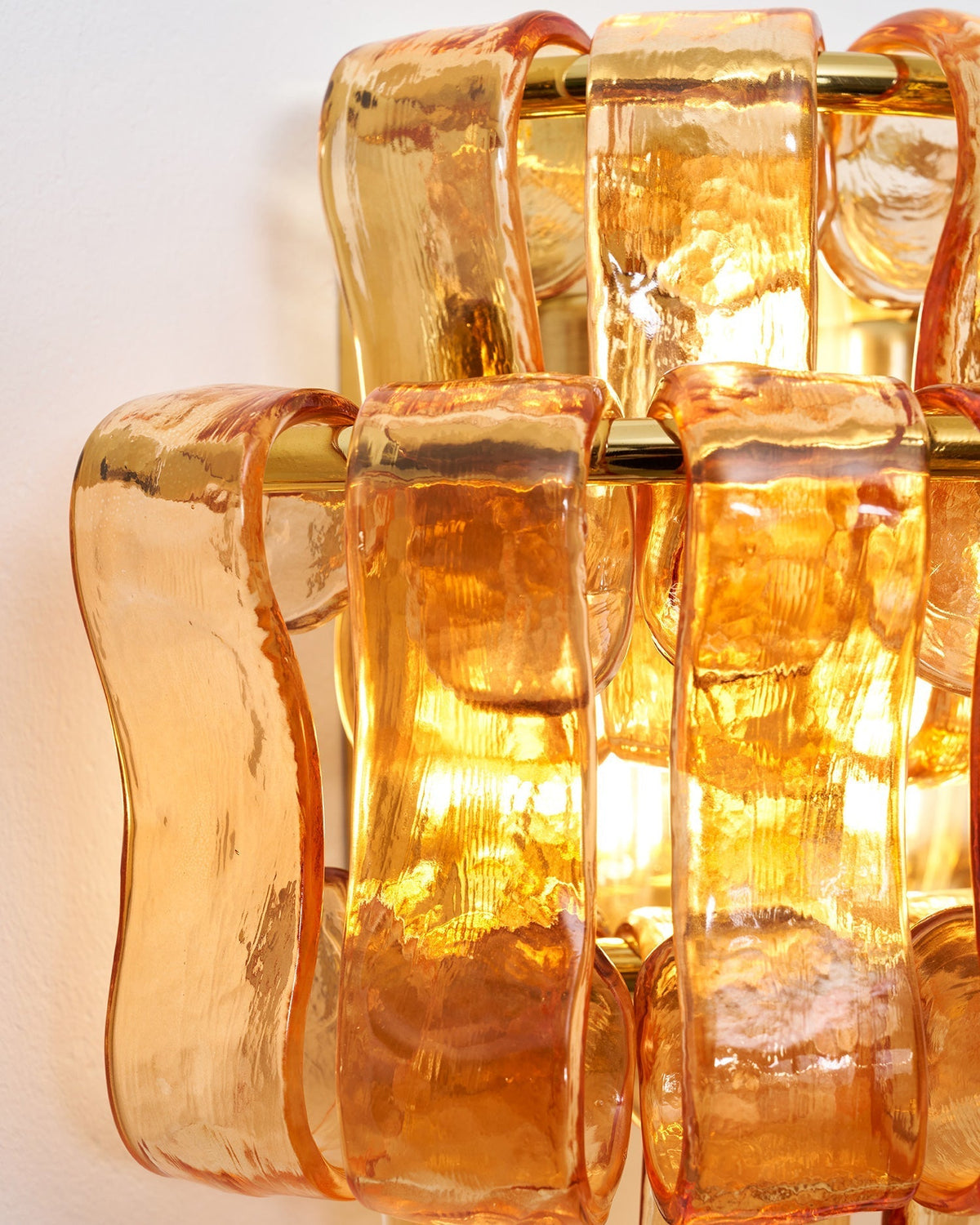 Albano Wall Lamp in gold glass, front view.
