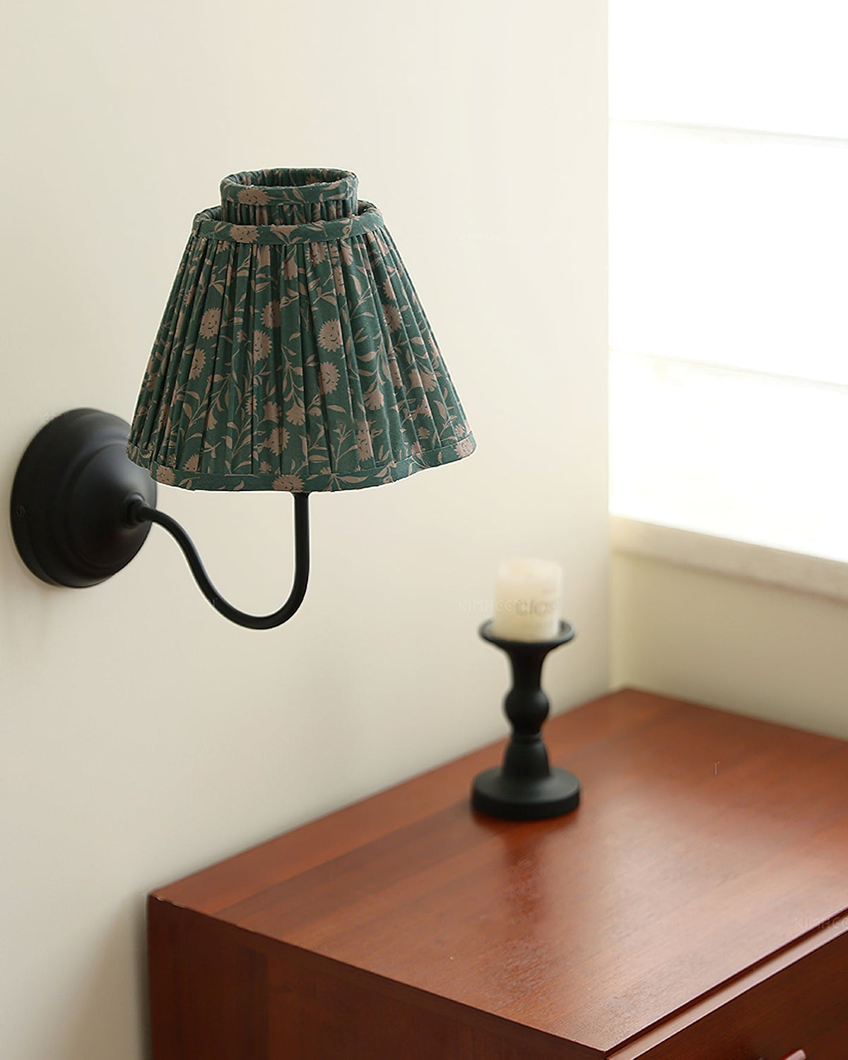 Angled view of the green and black version of the Elbow Wall Light.