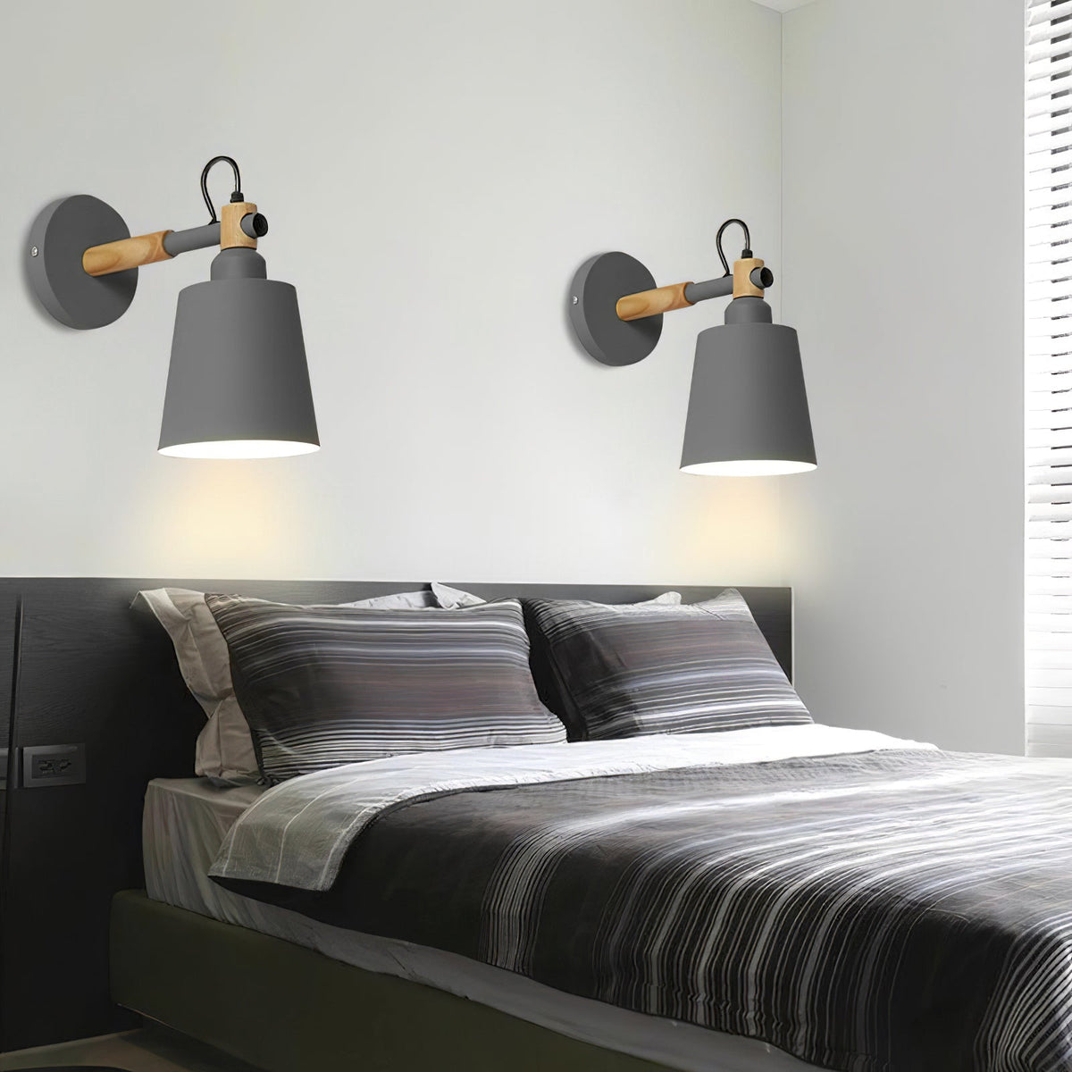 Copita Wall Lamp in black finish shown in a living room setting.