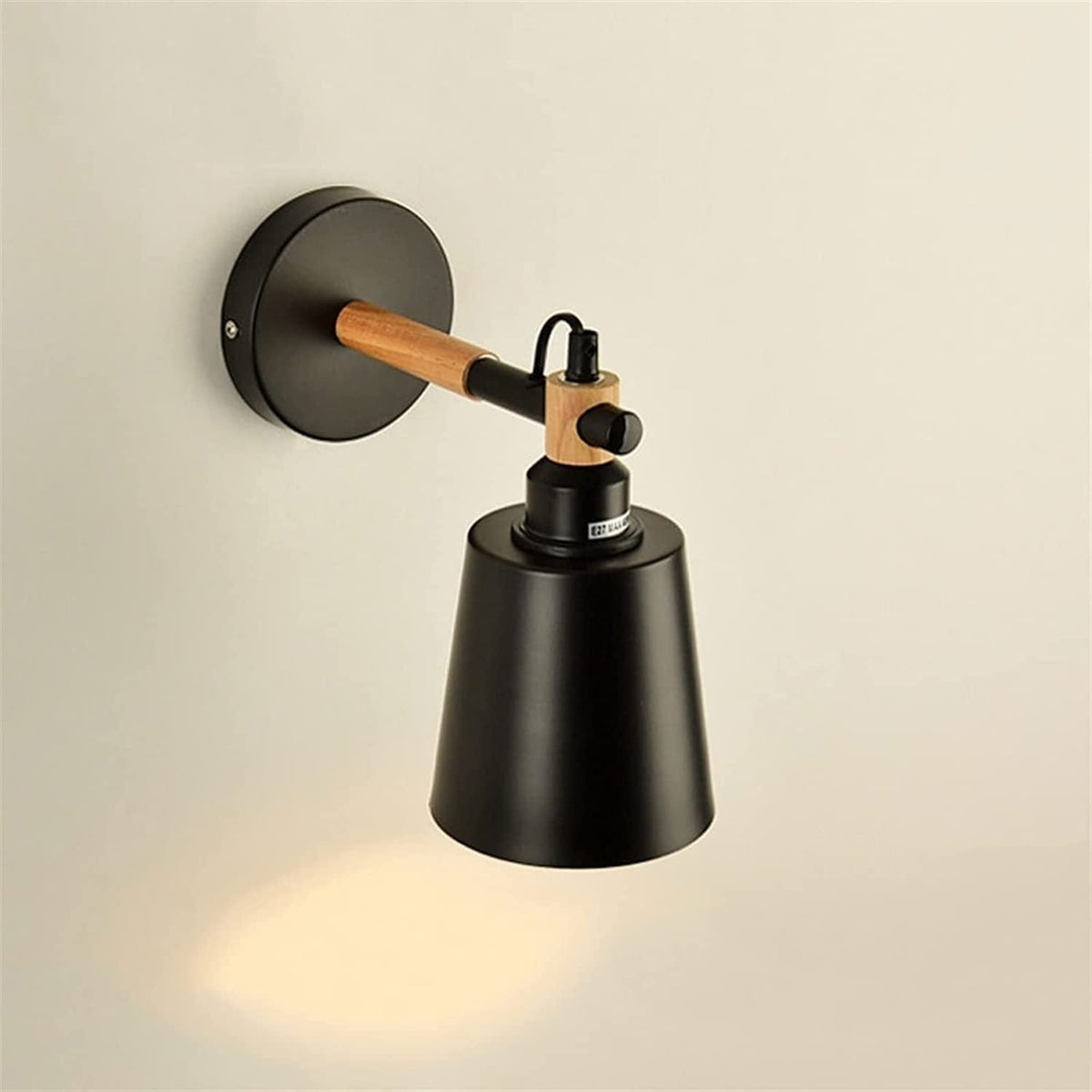Copita Wall Lamp in green finish against a dark wall.