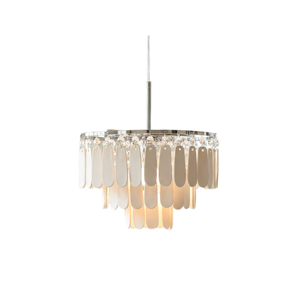 Modern pendant light with white ceramic petals hanging in a living room.