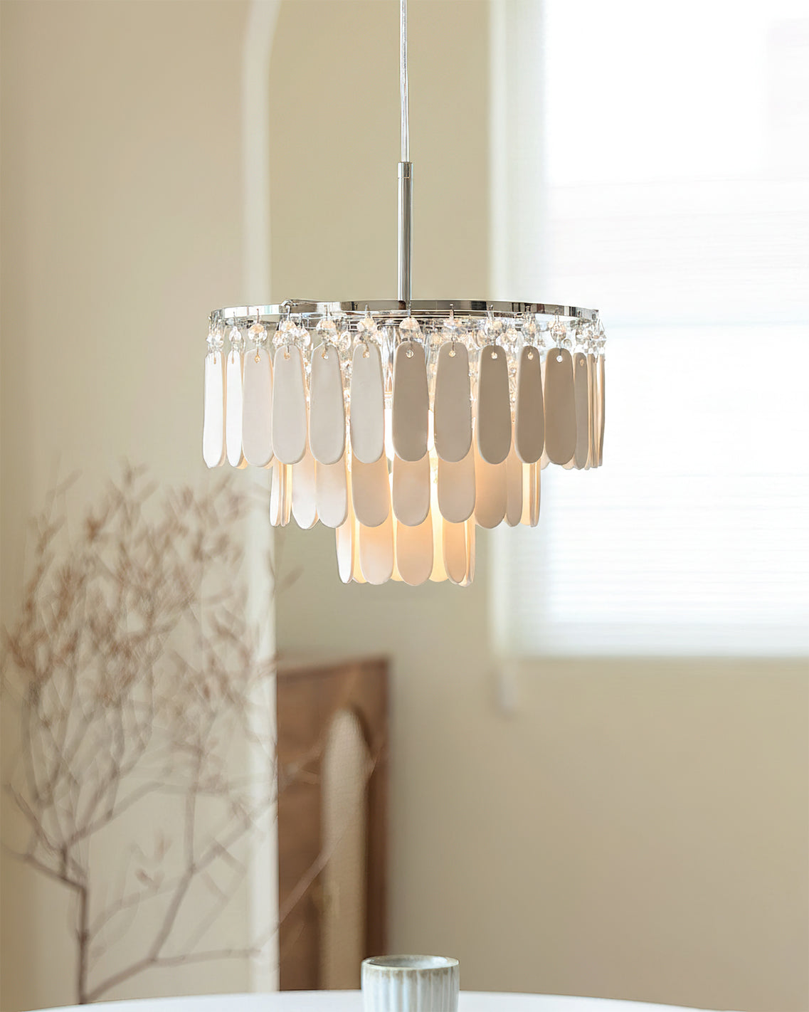 Pendant light illuminated, showing the soft glow through the ceramic petals.