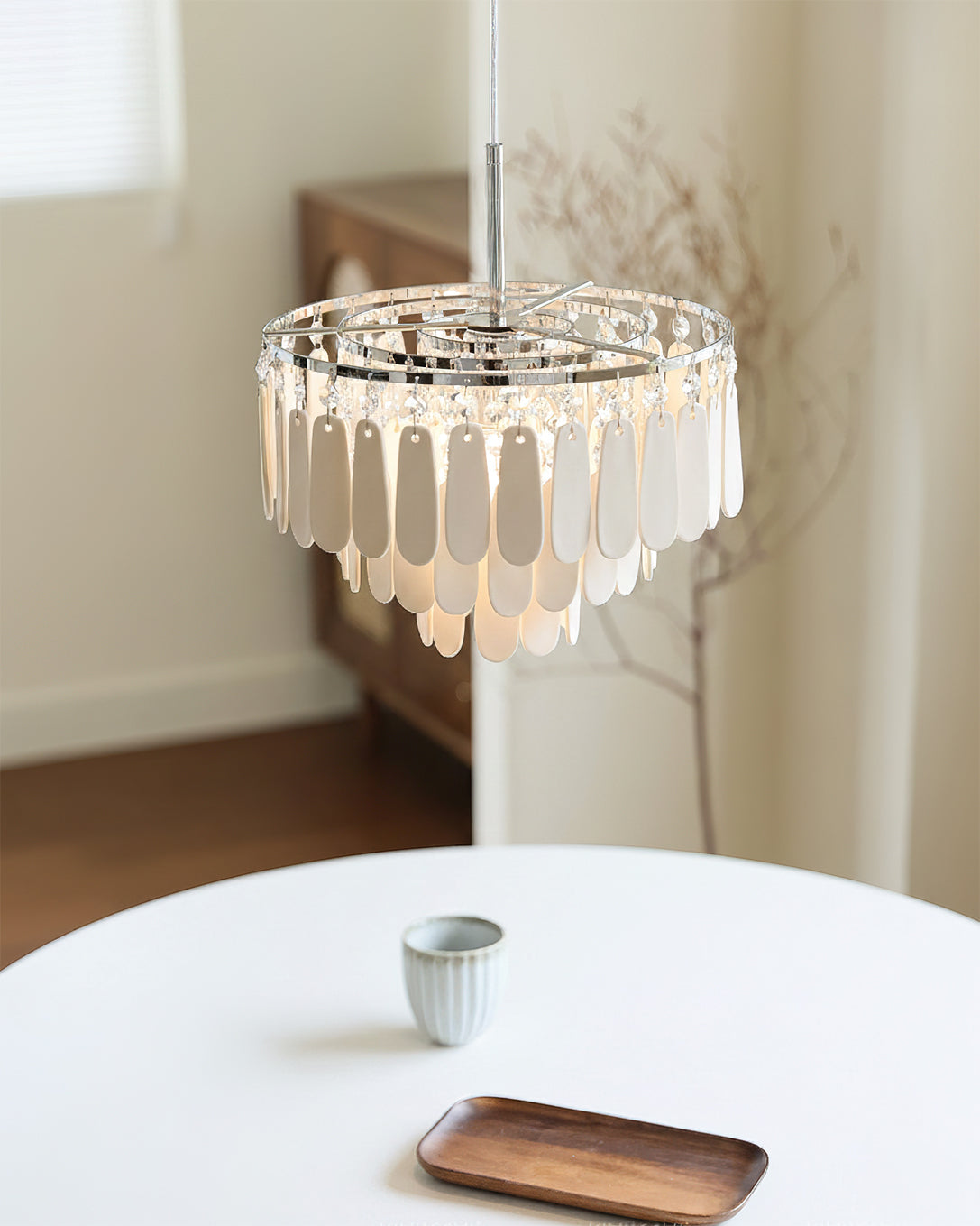 View of the pendant light from below, highlighting the crystal and bulb fixture.