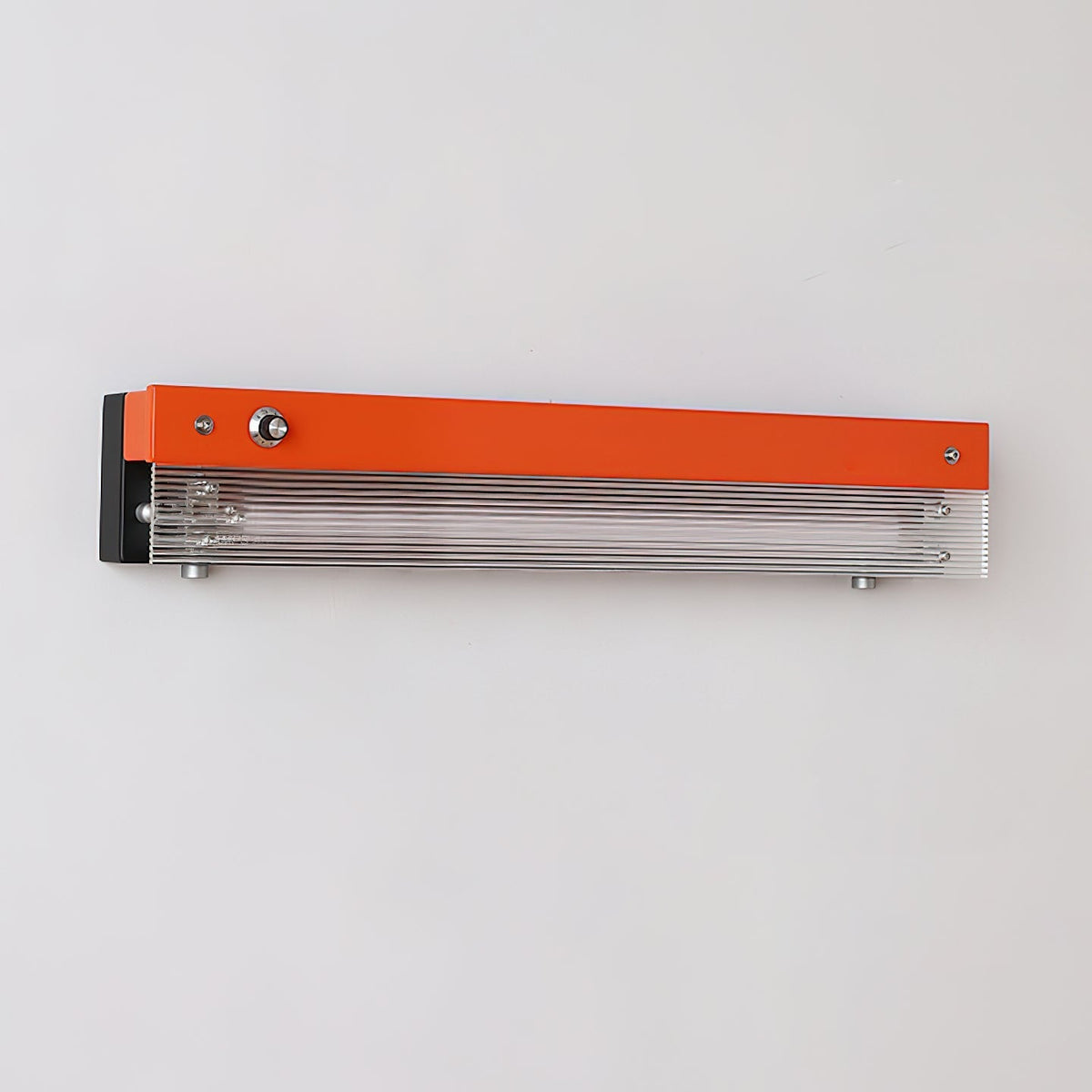 The red Totem Wall Lamp casting a warm, ambient light.