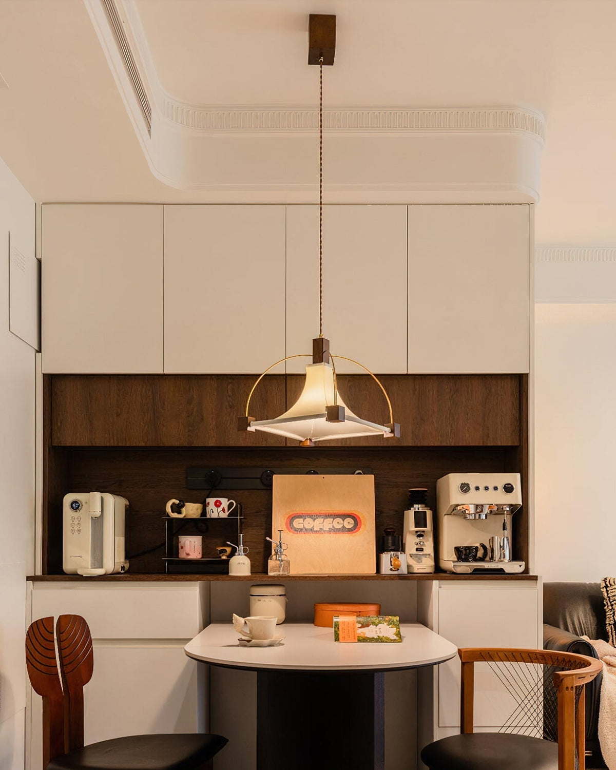 The pendant light shown with the light turned on, casting a warm glow