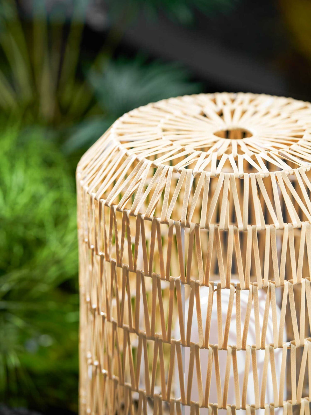 Woven rattan lamp styled on a modern outdoor deck.