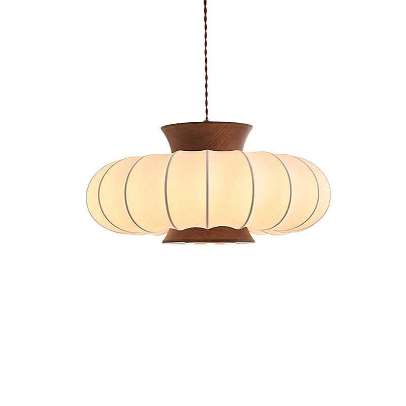 Aeron Pendant Light hanging over a wooden table.