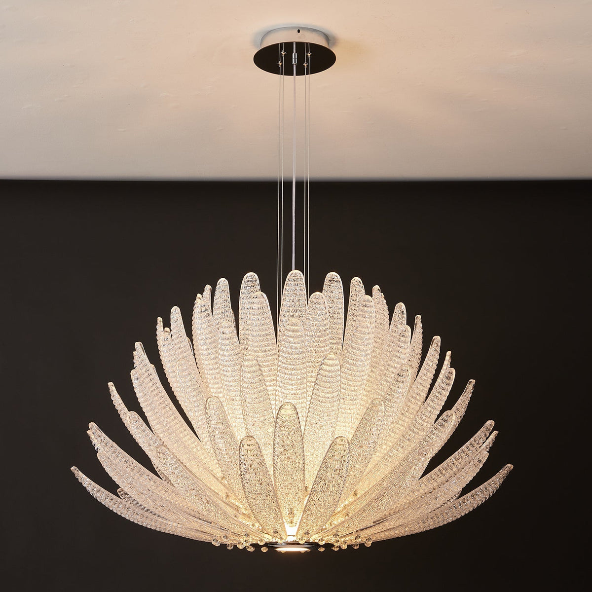 Detailed view of a single amber glass petal from the Agave Chandelier.