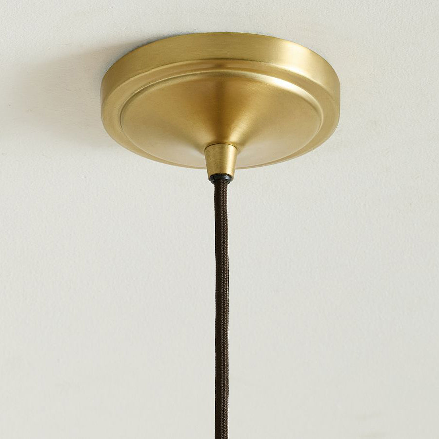Lifestyle image of the Agoura Pendant Light in a bohemian-style bedroom.
