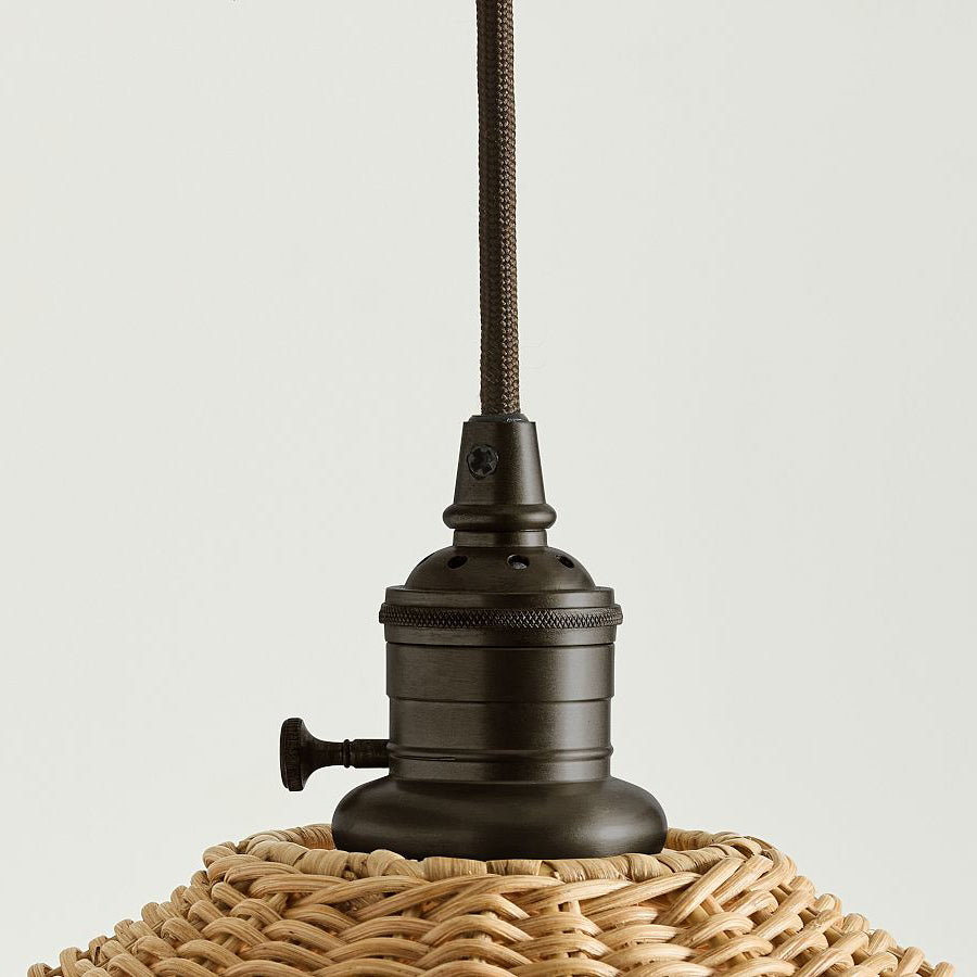 Angled view of the conical shade of the Agoura Rattan Pendant Light.