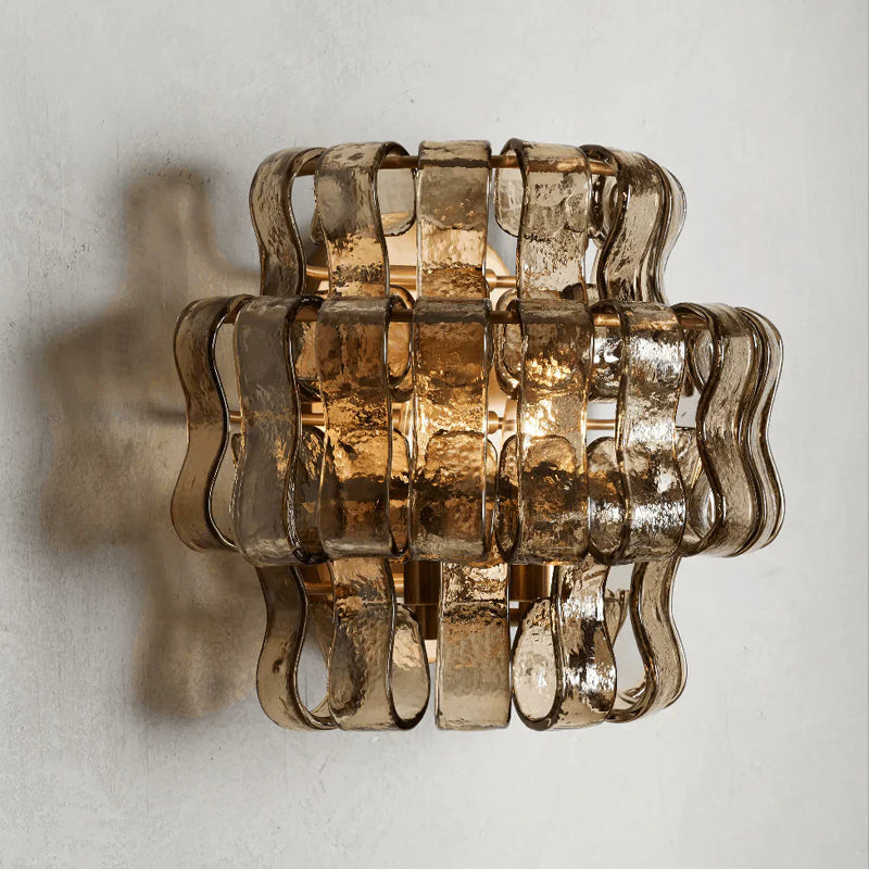 The sculptural form of the Albano Wall Lamp in clear glass.