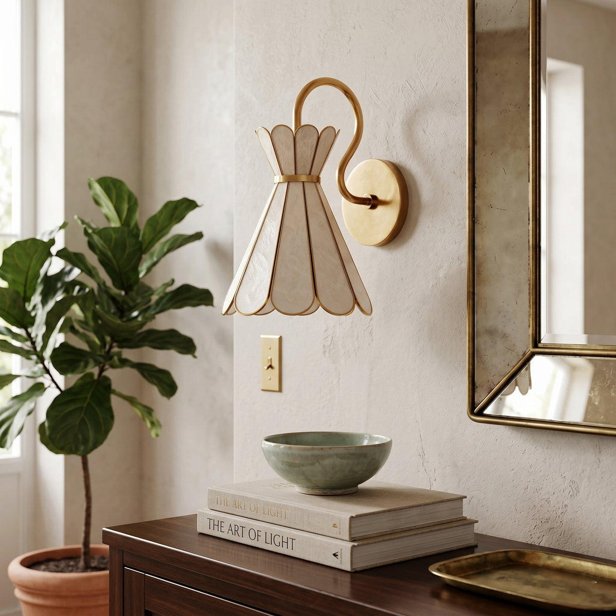 Close-up of the natural shell petals and brass details of the Alito wall light.