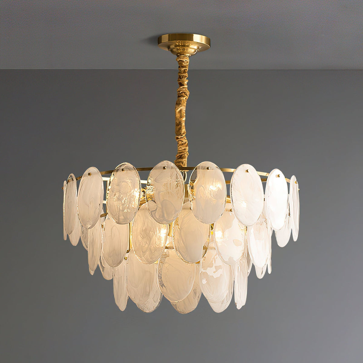 The Andante Glass Chandelier shown in a modern living room setting.