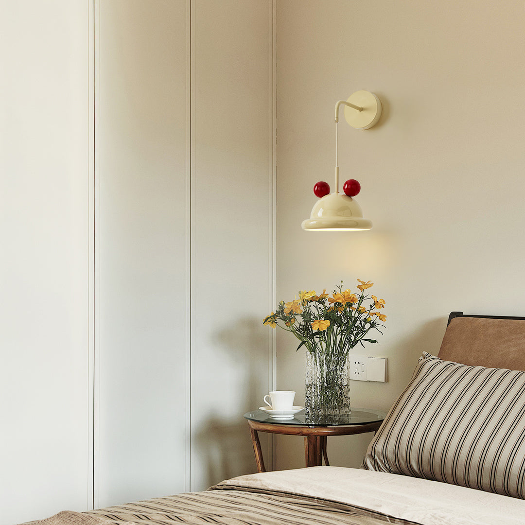 The wall lamp illuminating a cozy corner of a room.