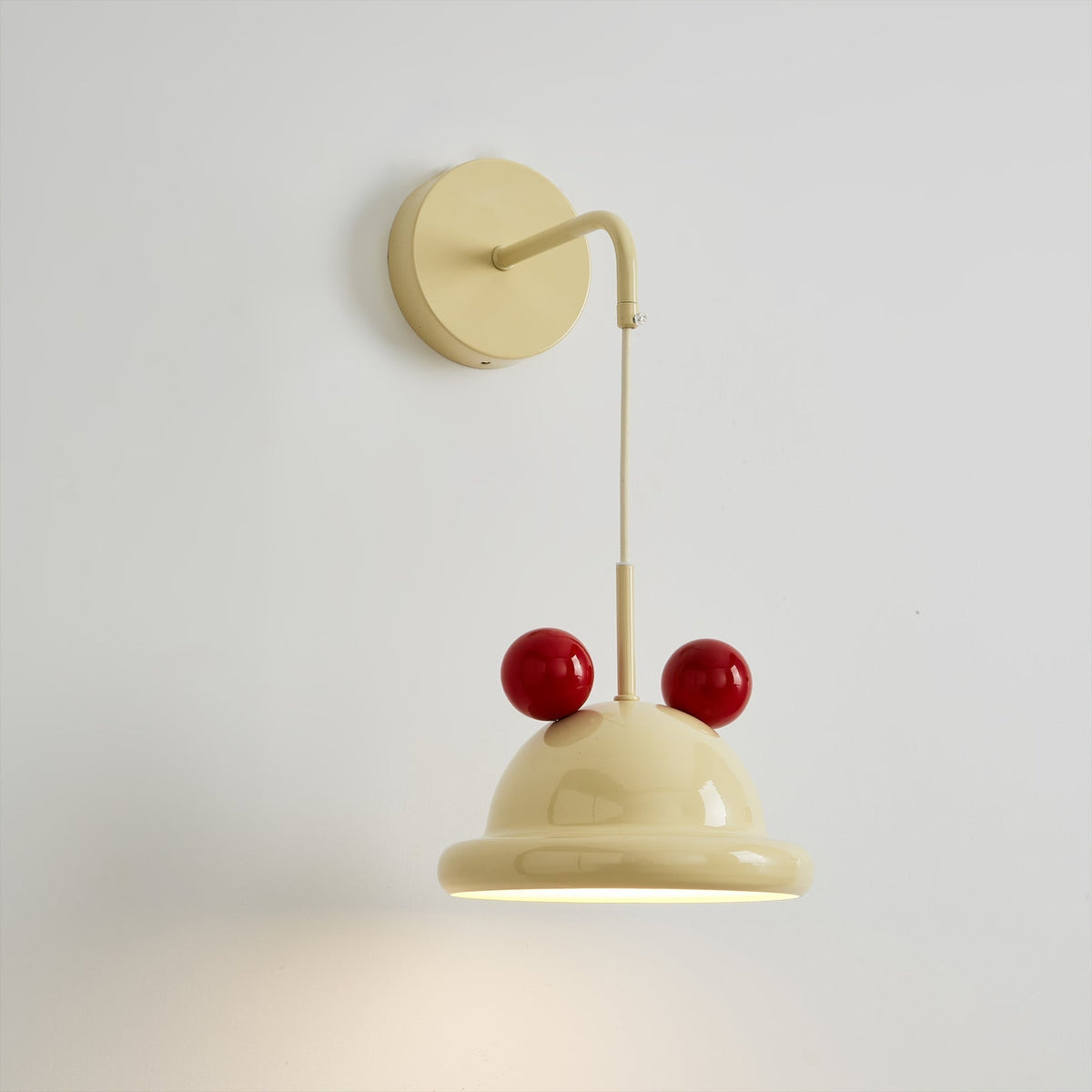 Close-up of the Aries Wall Lamp's dome shade and red sphere accents.