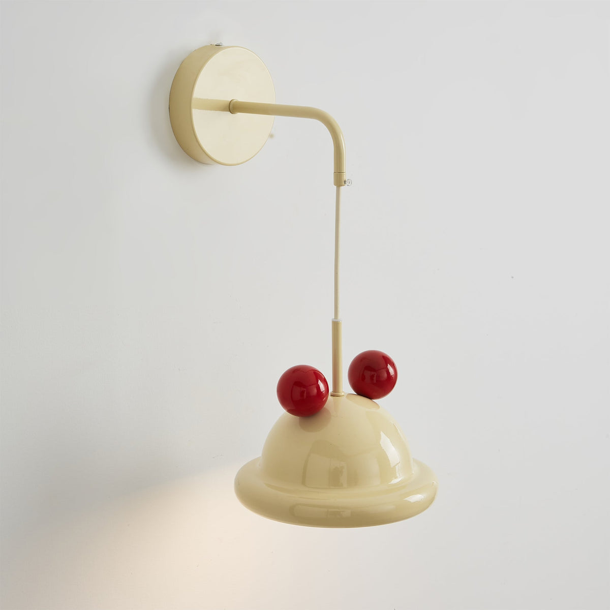The cream and red Aries Wall Lamp turned off.
