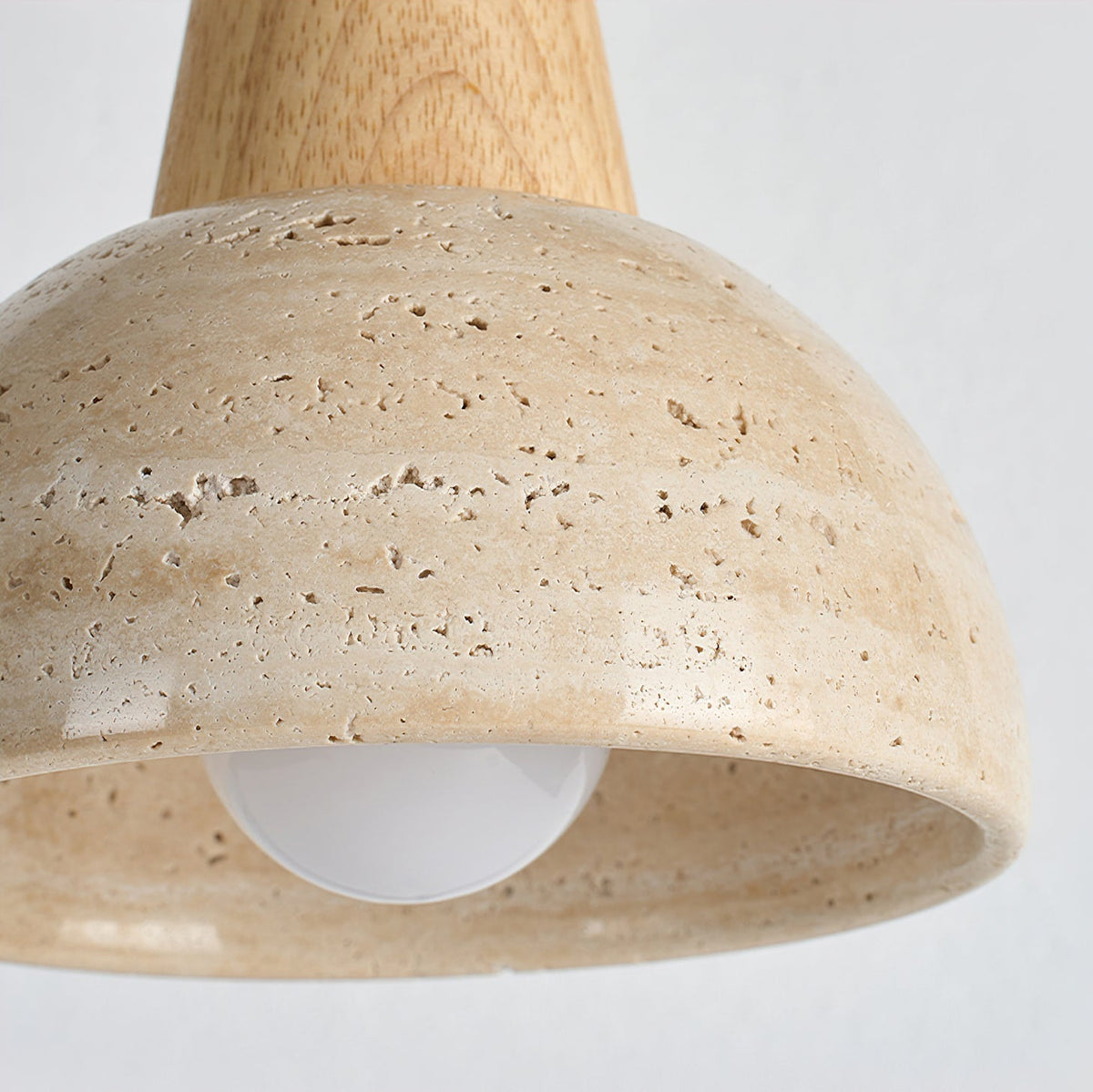 The dome-shaped silhouette of the Arluoe Travertine Pendant Lamp.