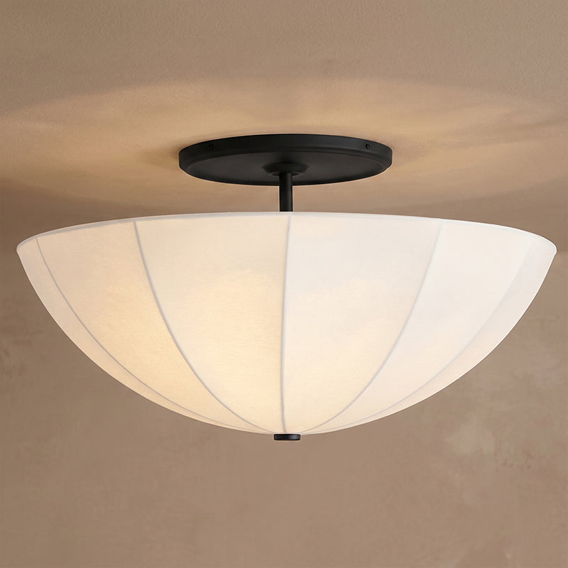 Lifestyle image of the Auden semi-flush mount in an elegant nursery space.