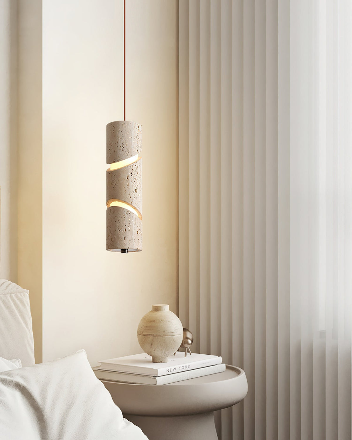 Detail shot of the light glowing through the artistic cutouts of the pendant.