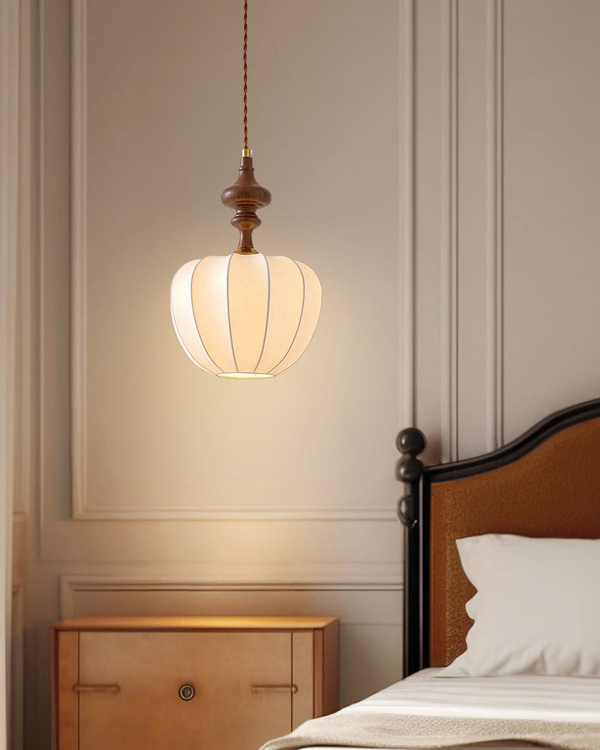 The Baird Pendant Light illuminated in a dark room.