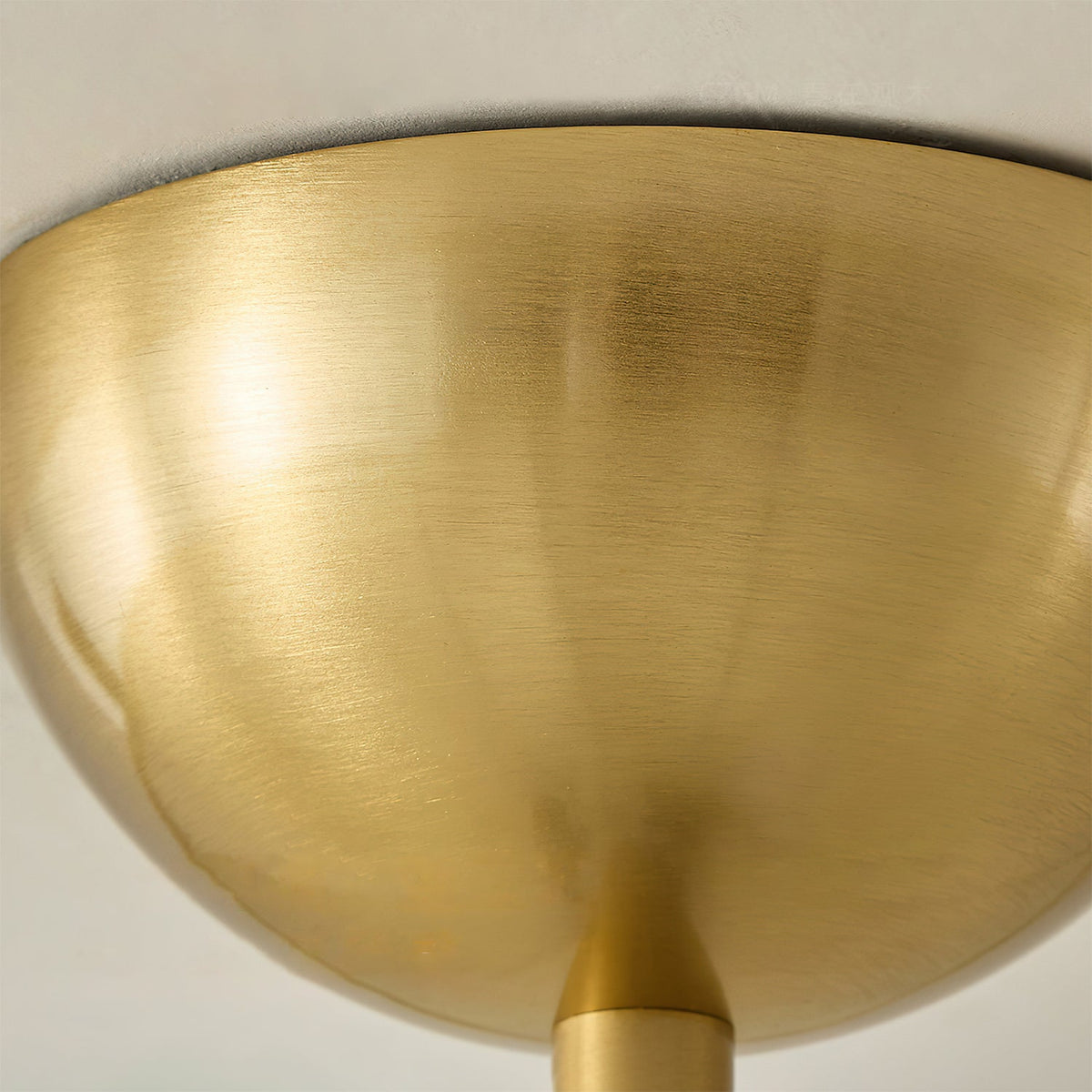 The scalloped petal silhouette of the ceiling light in a dressing room.