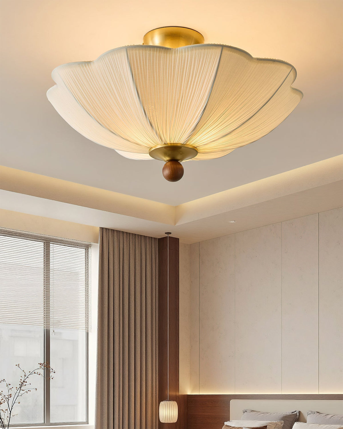 Close-up view of the pleated beige fabric shade and walnut accent.