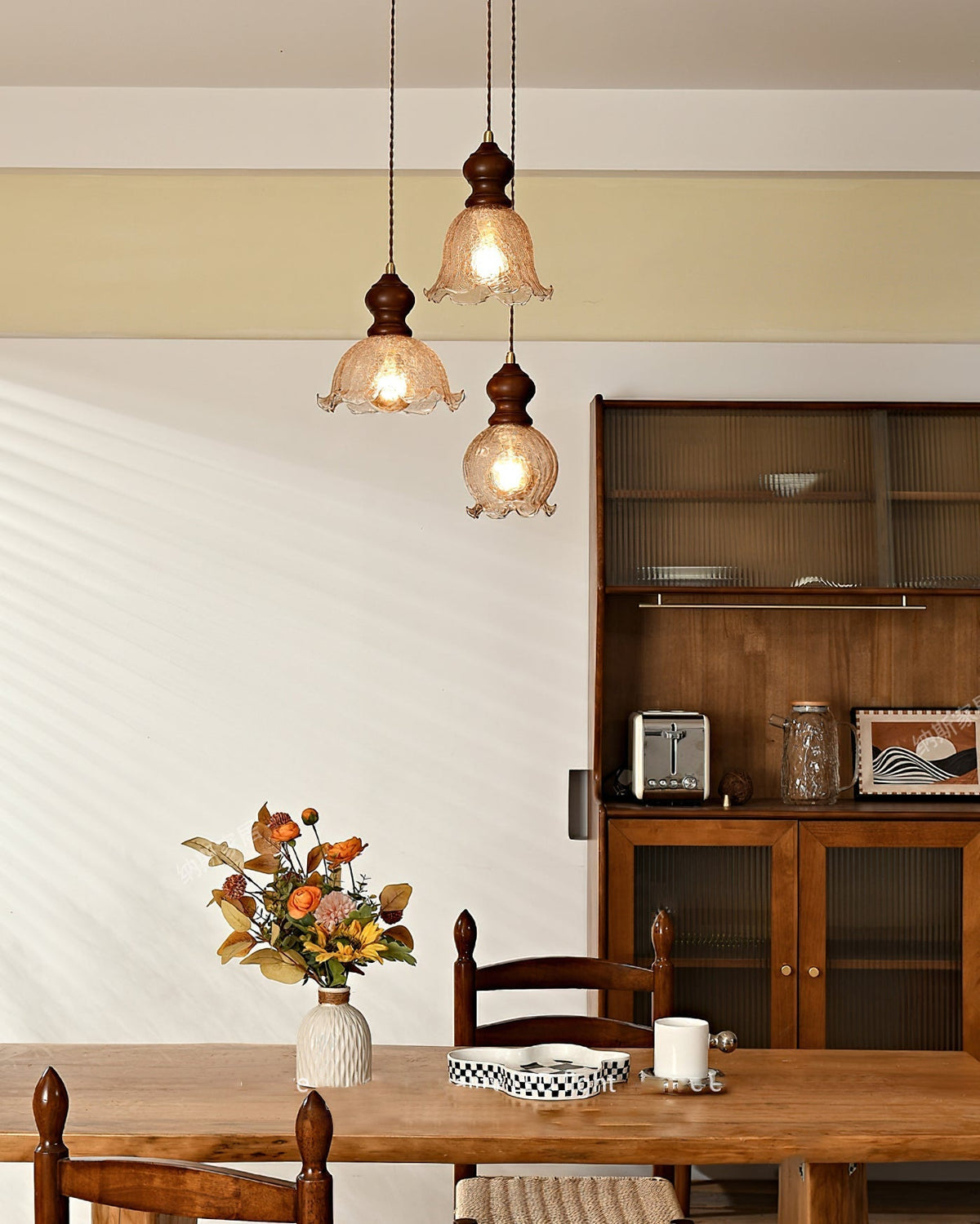 Close-up of the Barron Pendant Light's textured amber glass and wood top.