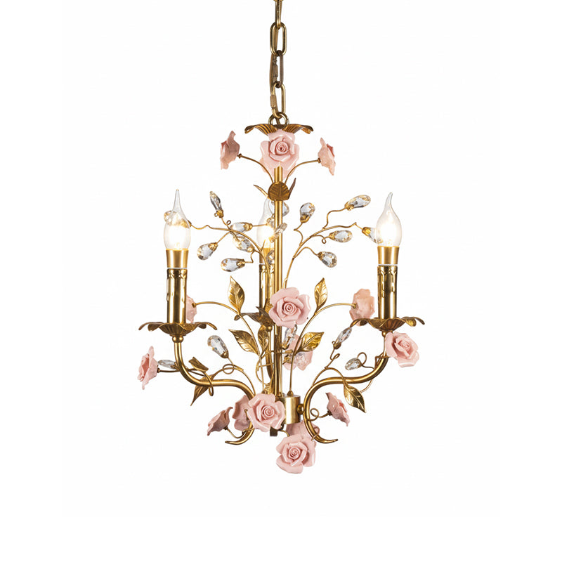 The Bassano Chandelier unlit, showcasing the brass and pink ceramic materials.