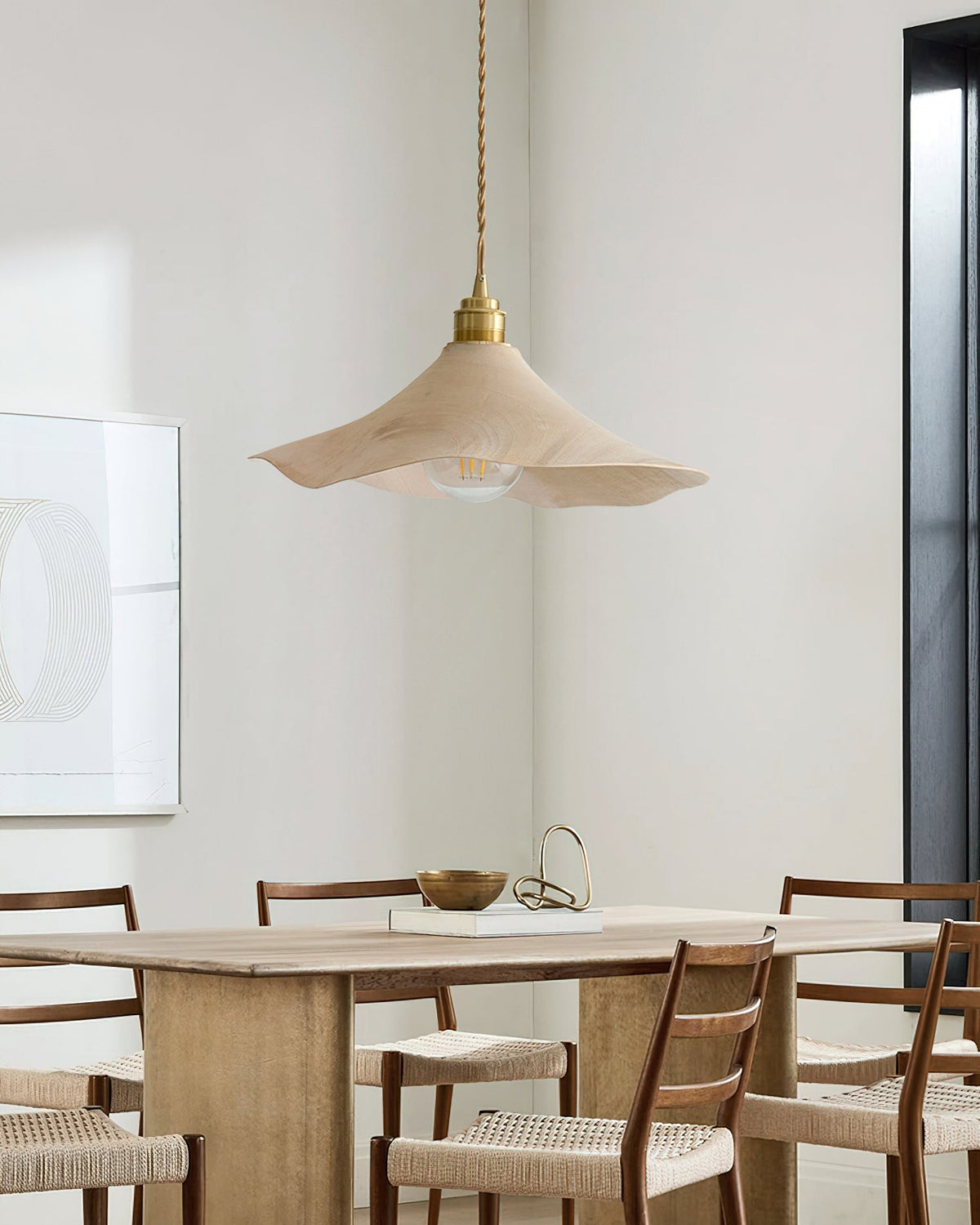 The Baxter Pendant Light hanging over a modern dining table.