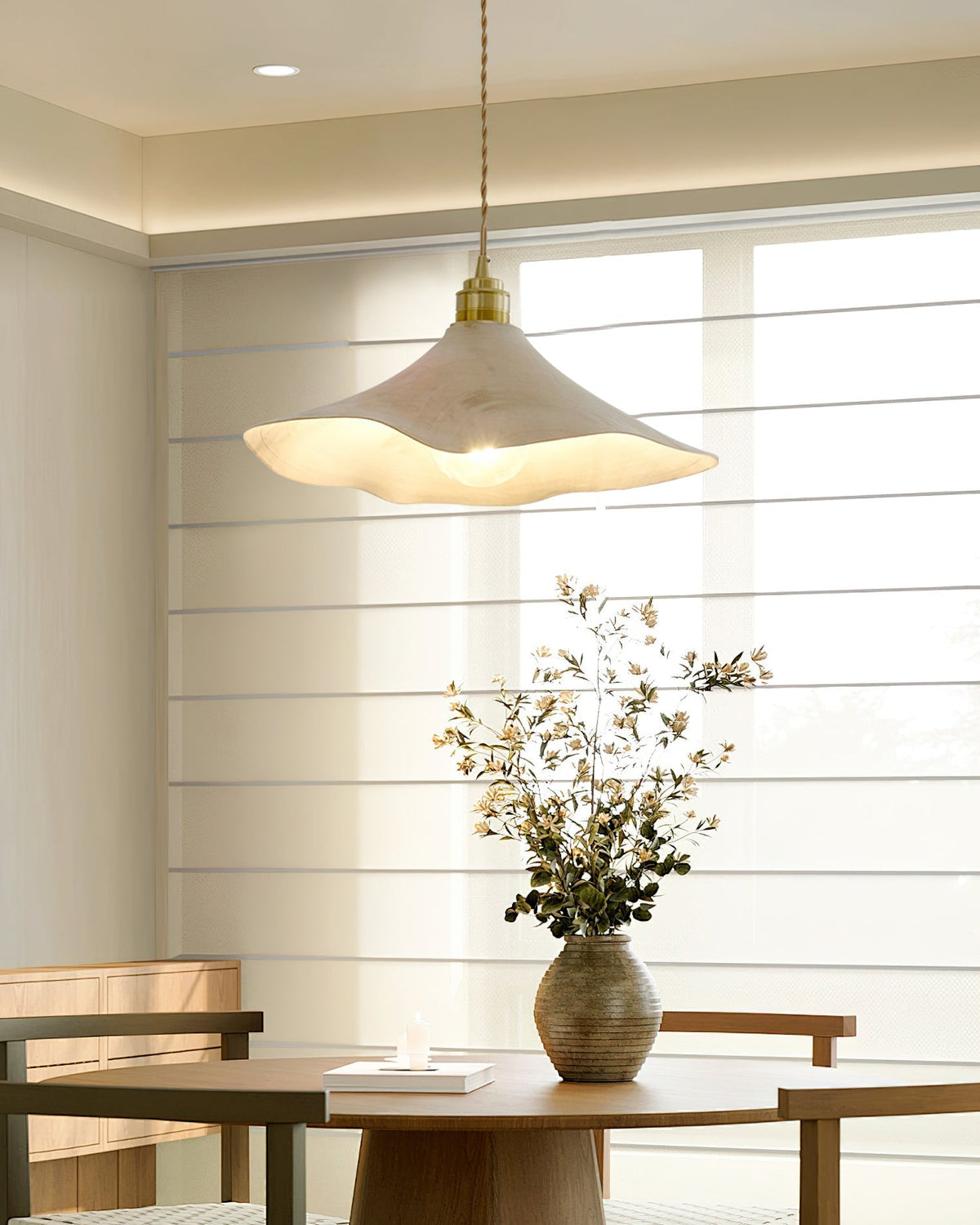 Angled view of the Baxter Pendant Light highlighting its sculptural form.