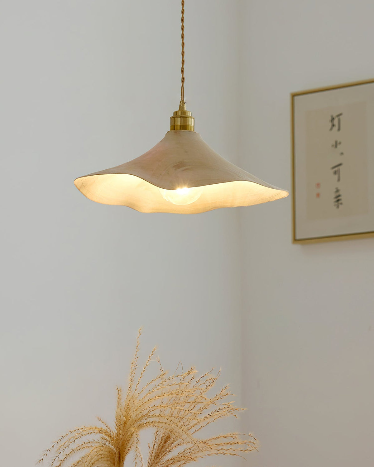 The Baxter Pendant Light shown illuminated, casting a warm ambient glow.
