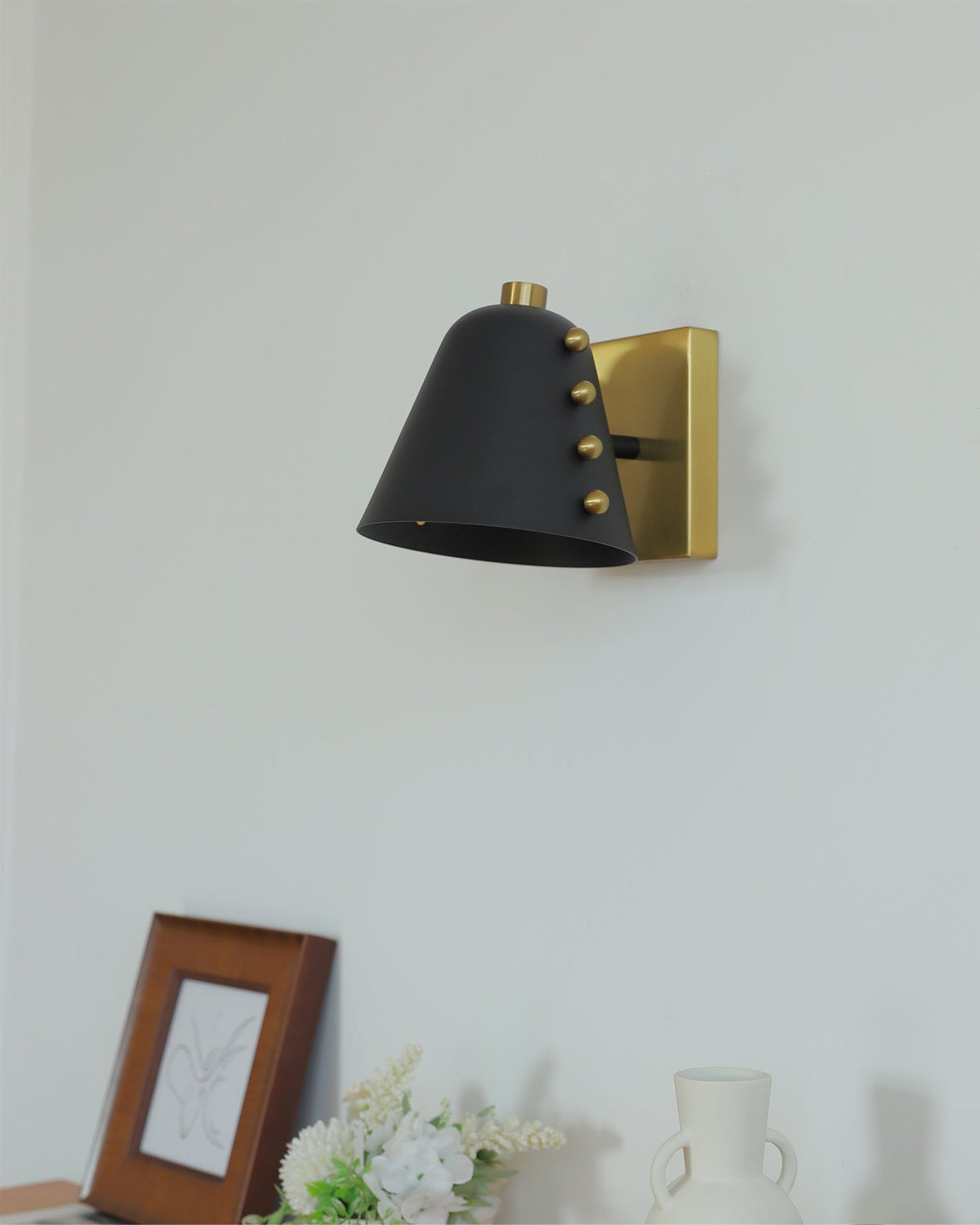 Close-up of the gold finish on the Bespoke wall lamp.