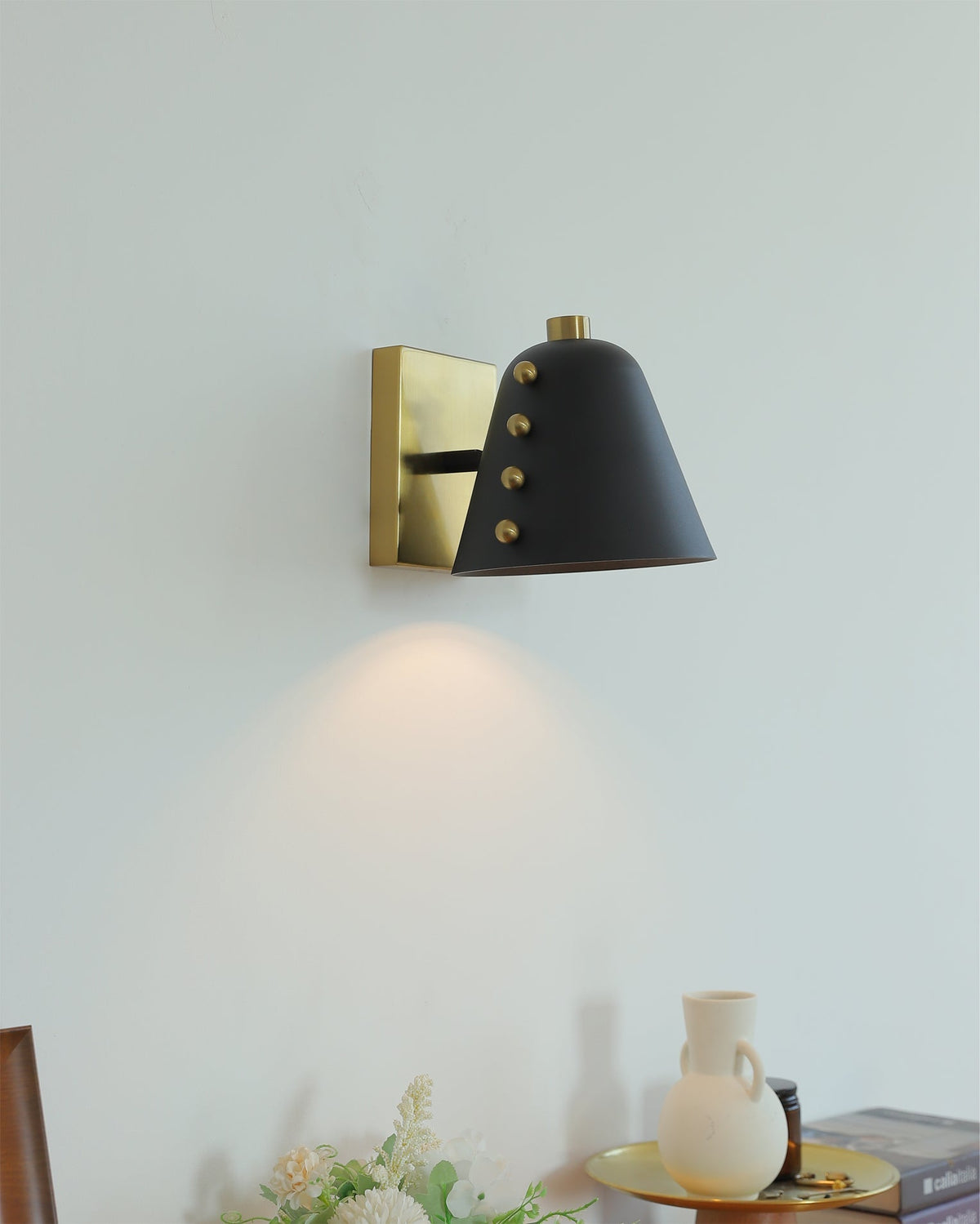 The sculptural form of the Bespoke wall lamp against a plain background.