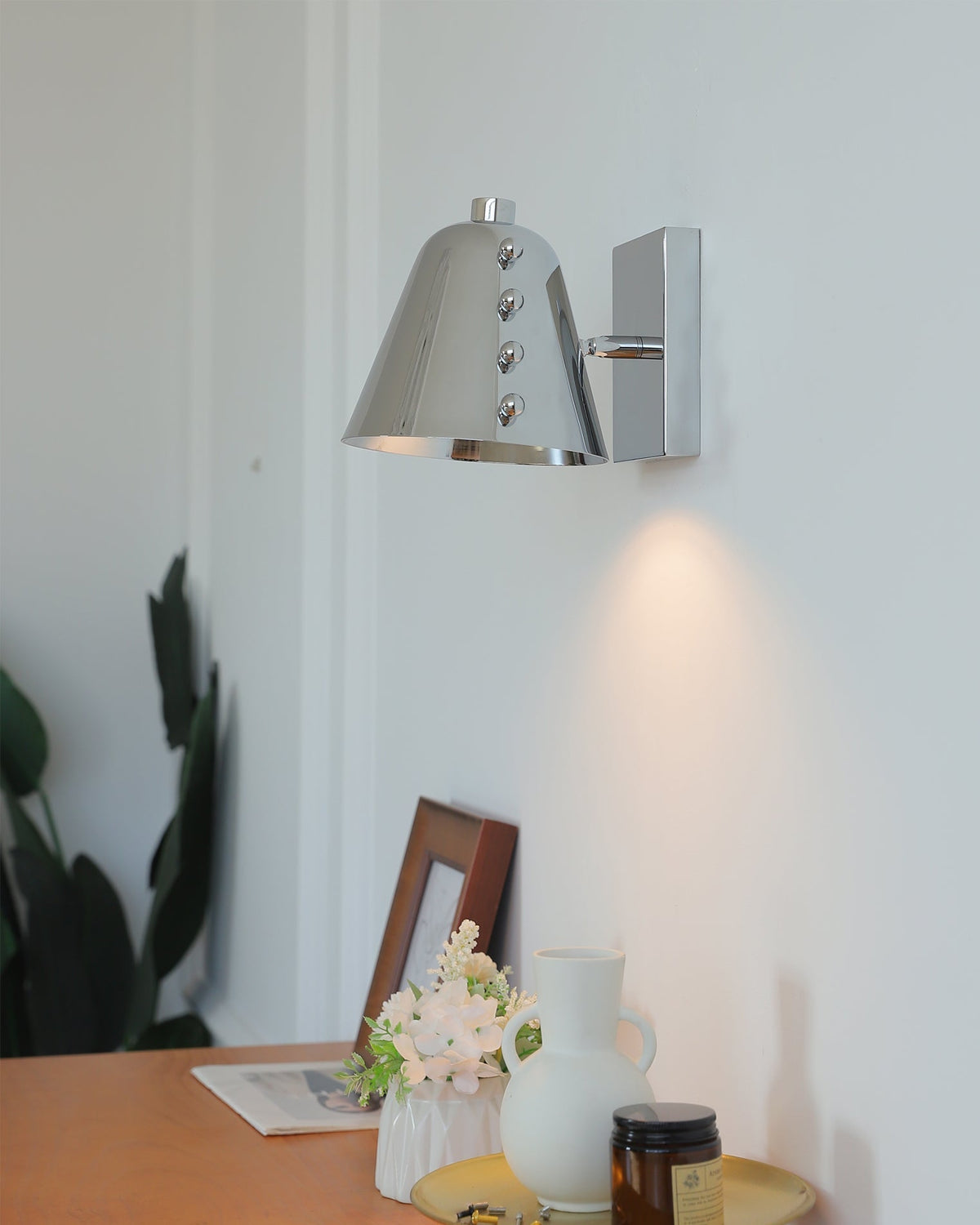 Bespoke wall lamp casting a warm glow in a lounge area.