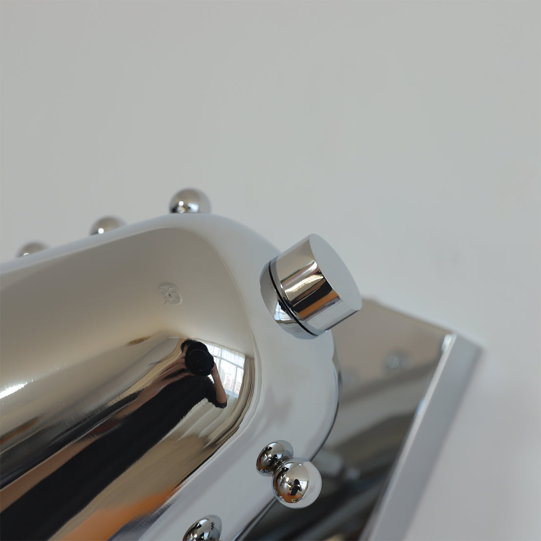 Bespoke wall lamp in gold, viewed from below.