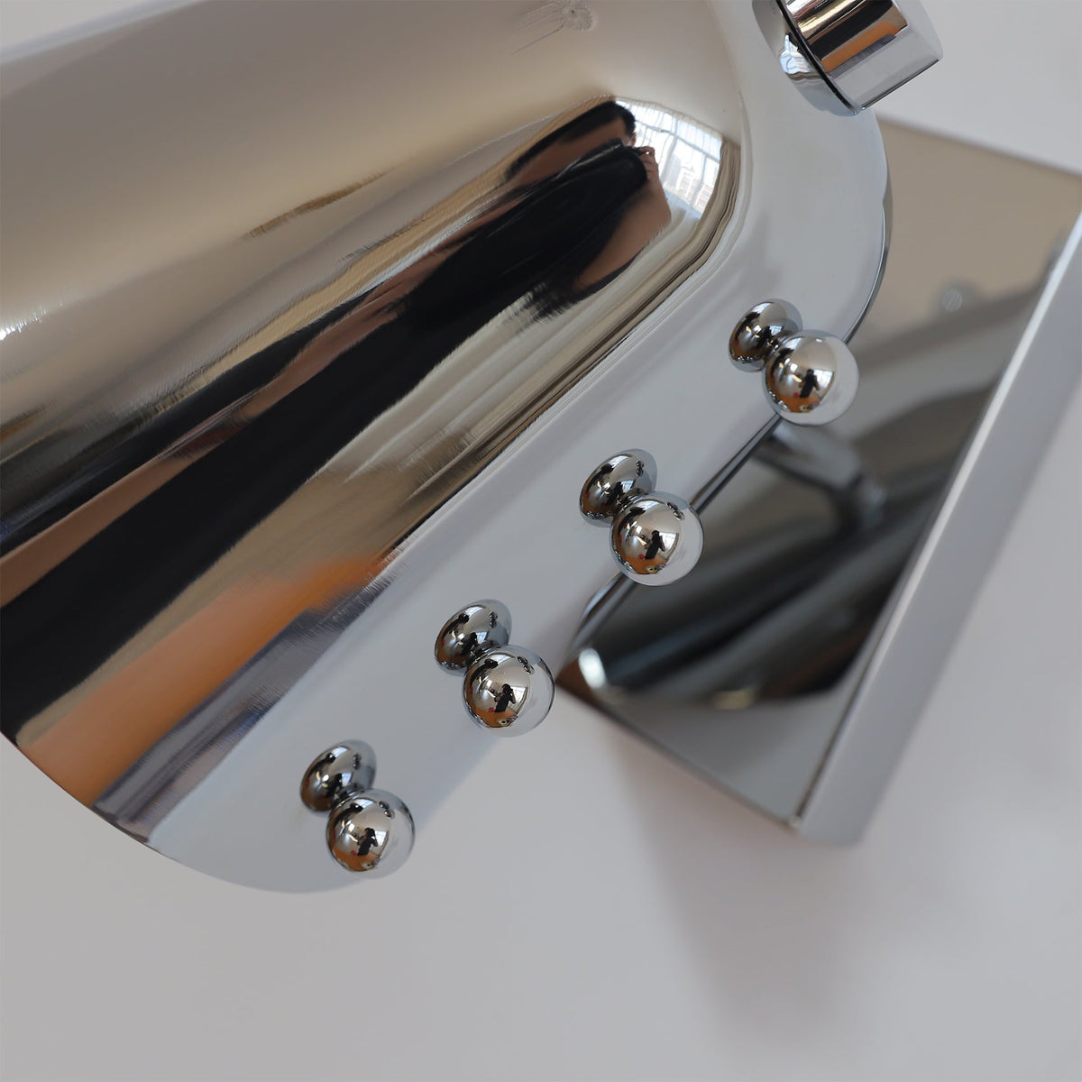 Bespoke wall lamp in black, viewed from the side.