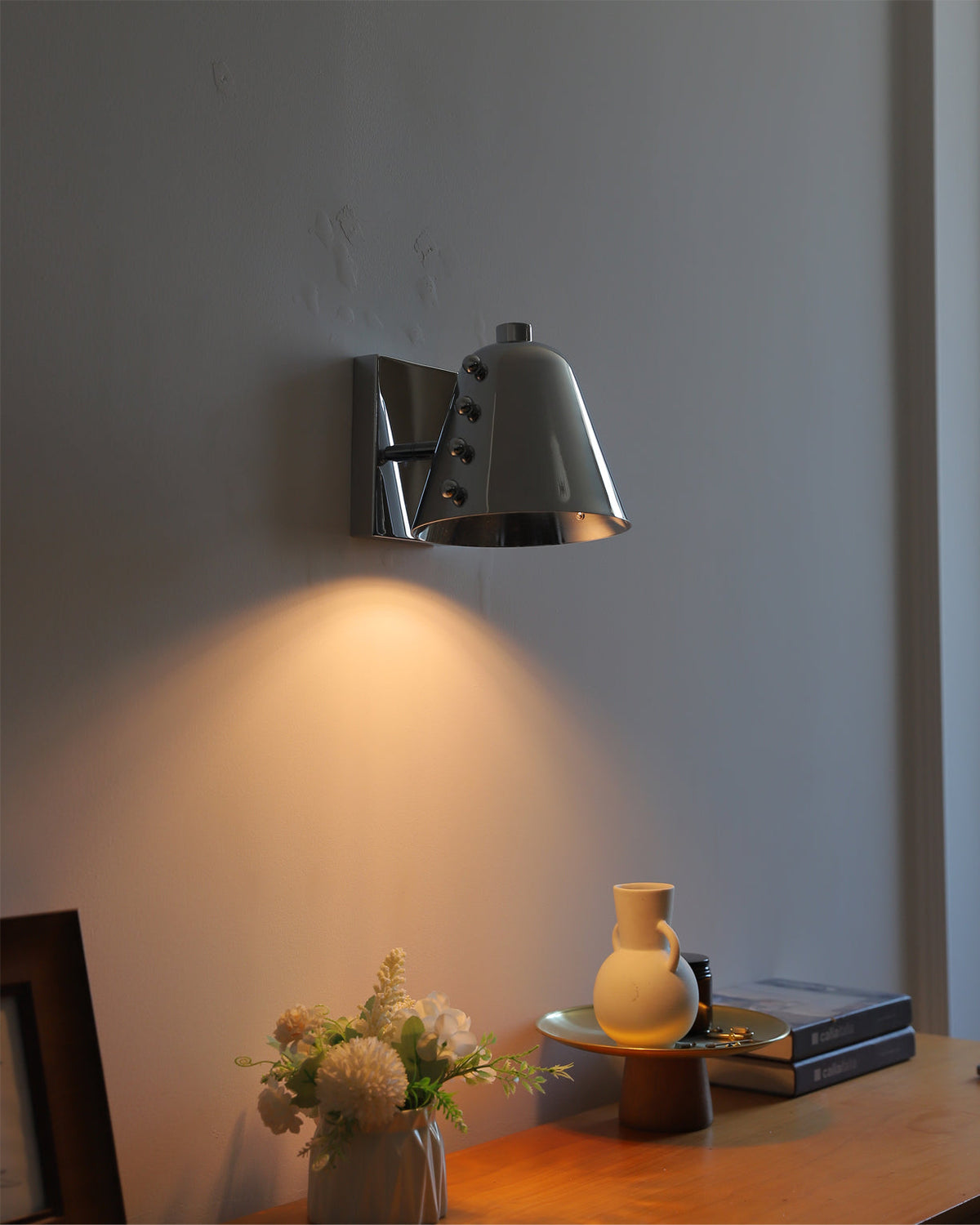 Installation view of the Bespoke wall lamp on a textured wall.