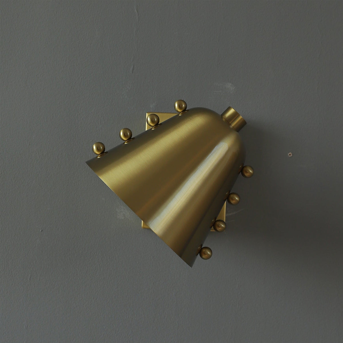 The three available finishes (gold, black, chrome) of the Bespoke wall lamp shown side-by-side.