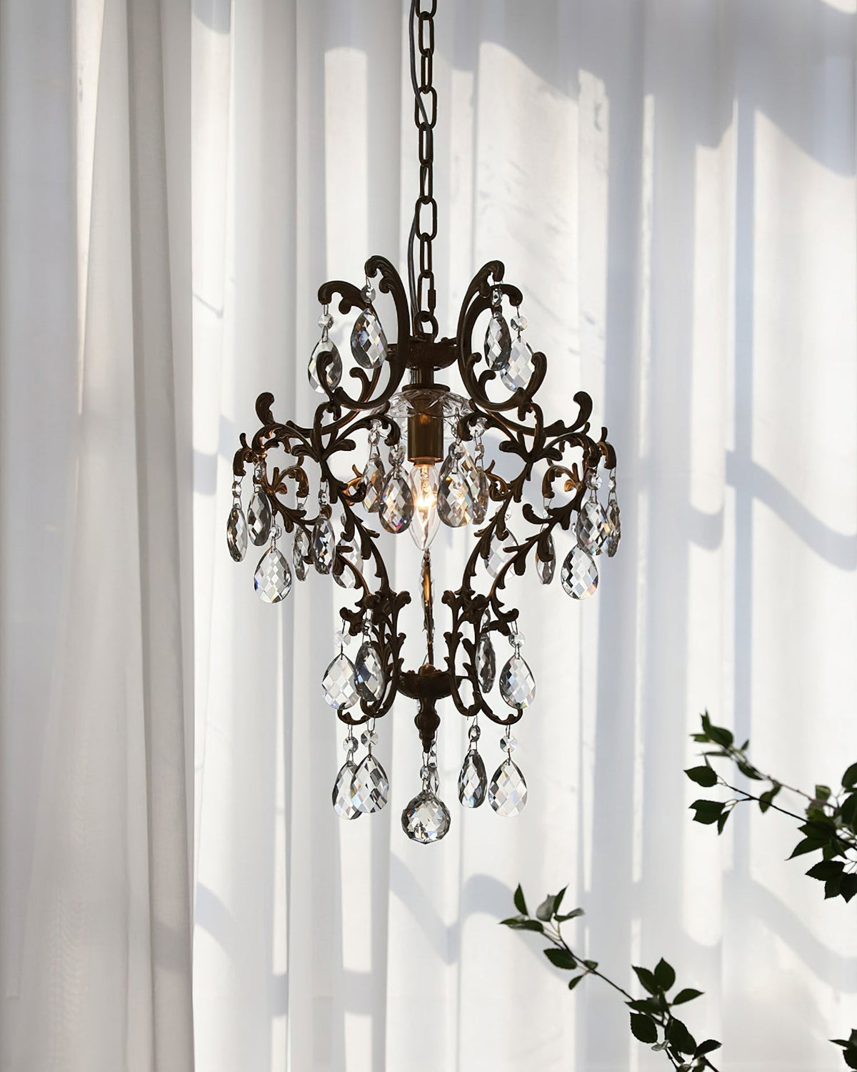 The bronze pendant light illuminated in a dining area.
