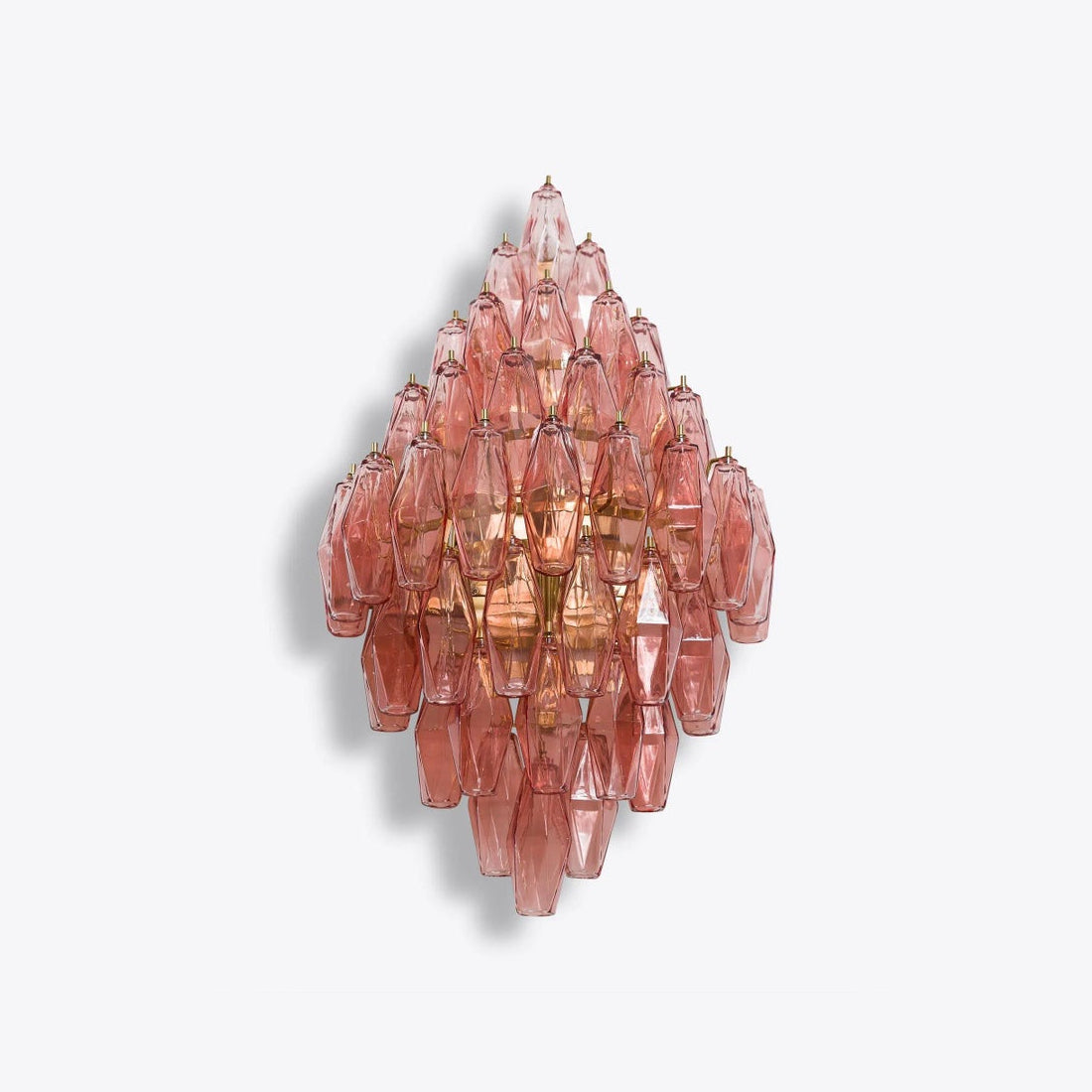 Biscayne sconce in amber finish, creating a warm glow.