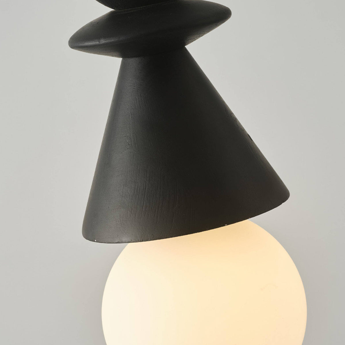 The natural wood version of the Bodie pendant light in a living room setting.