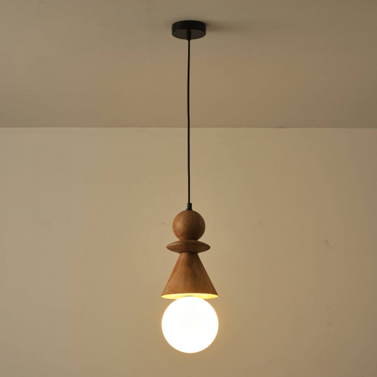 A single Bodie pendant light used as a bedside lamp.