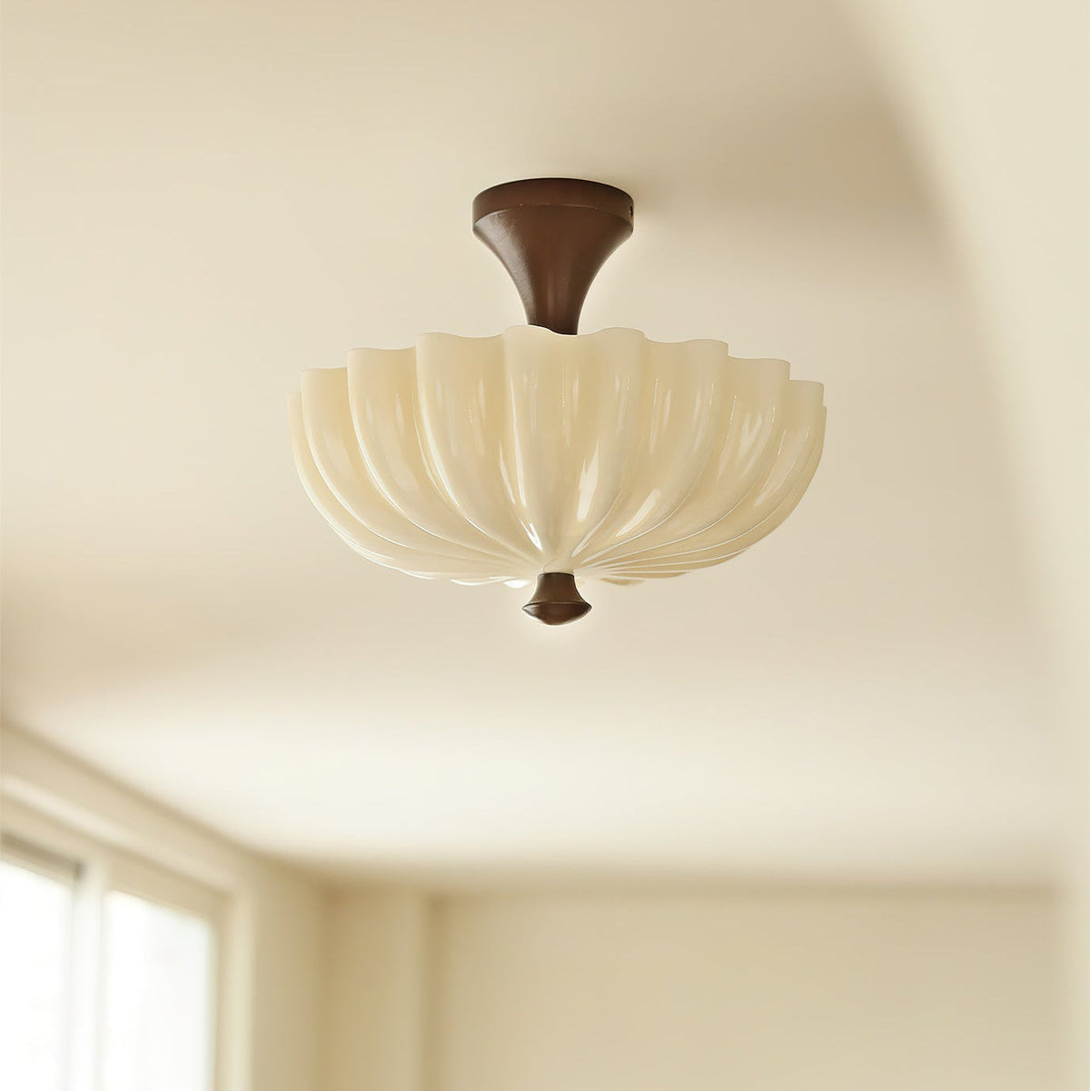 Close-up of the Bofea Ceiling Lamp's delicate glass shade, illuminated.