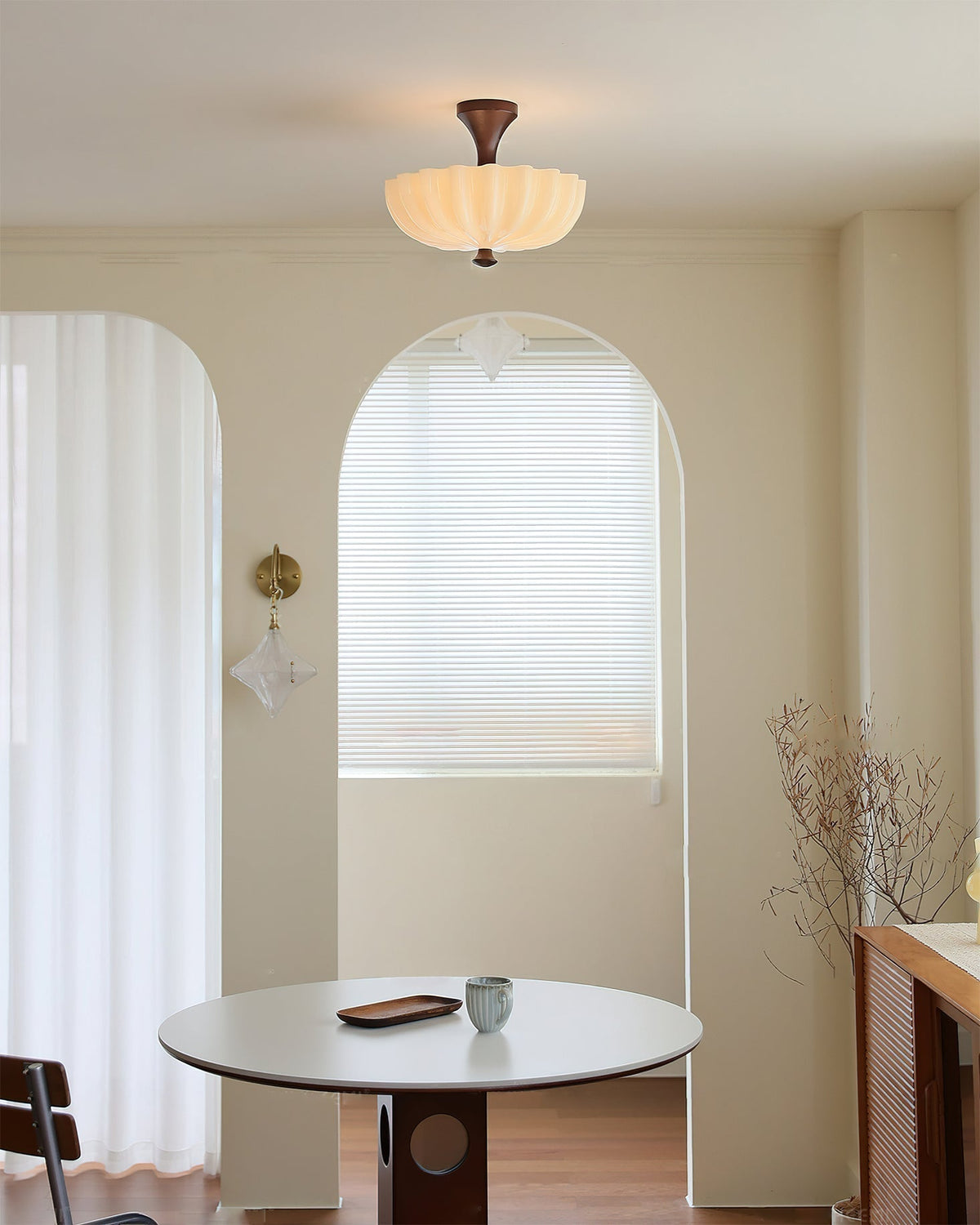 The ceiling lamp shown in a cozy bedroom setting, providing warm light.