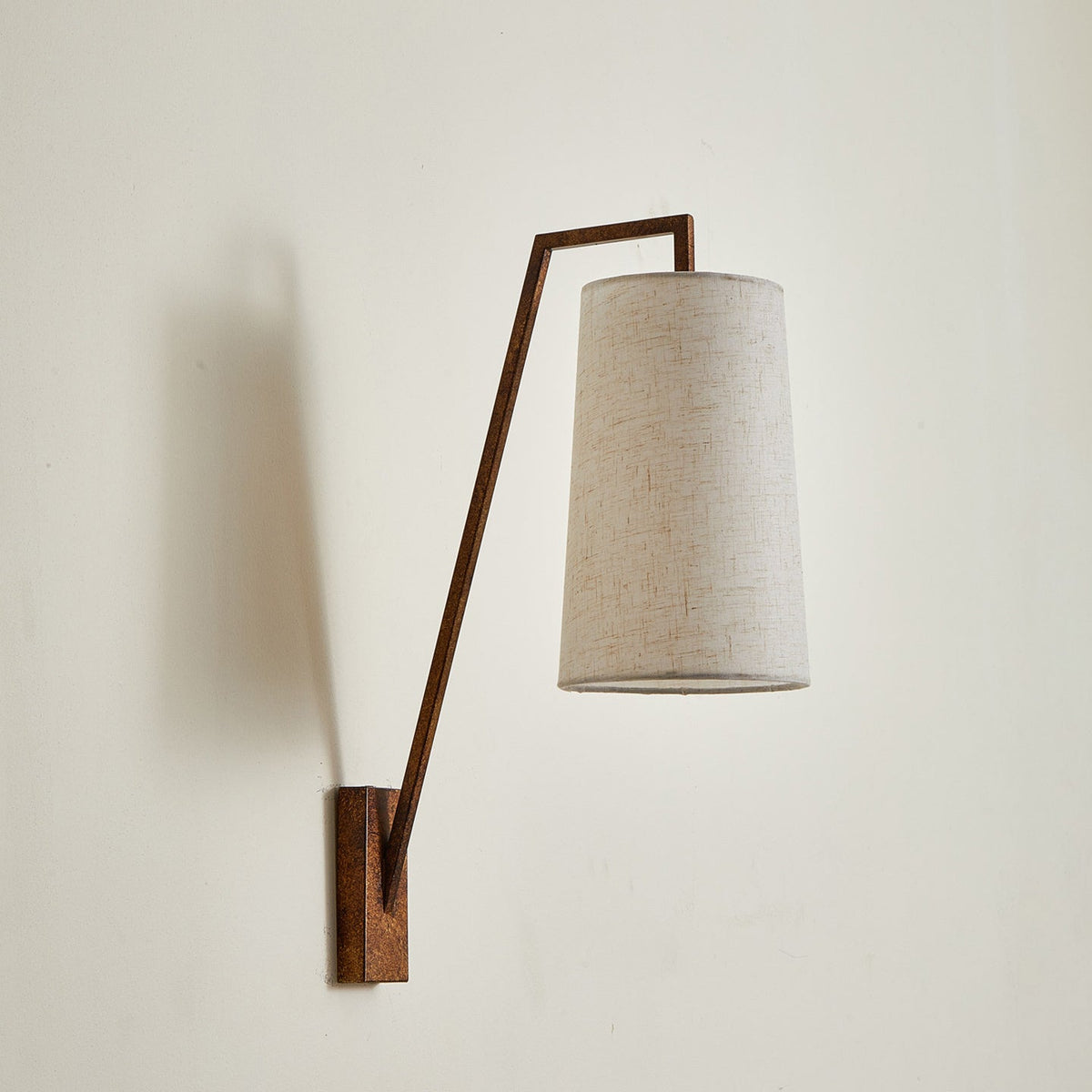 The Bonny Wall Light casting a soft, architectural glow.