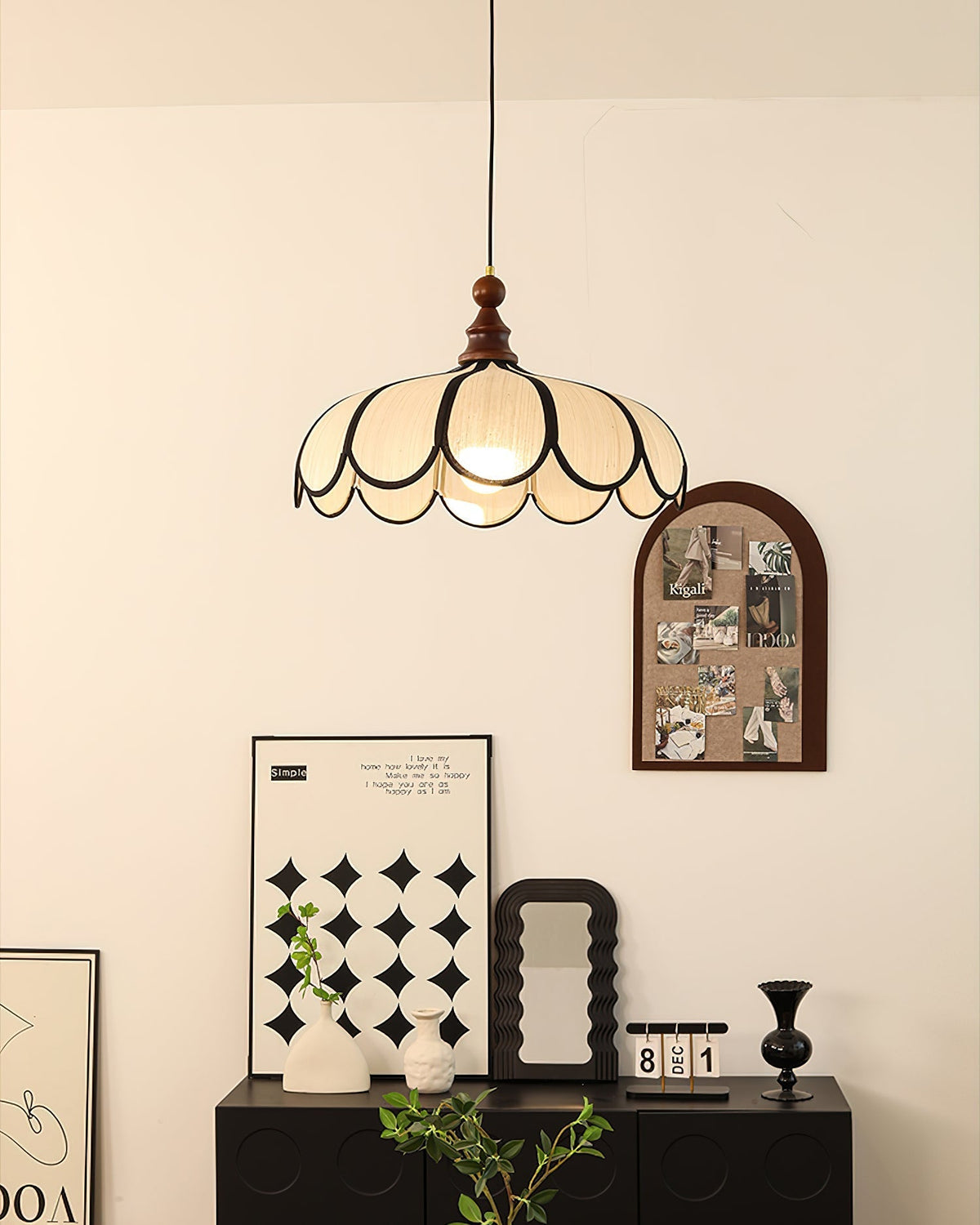The Botan Pendant Light providing warm, ambient light in a living room corner.